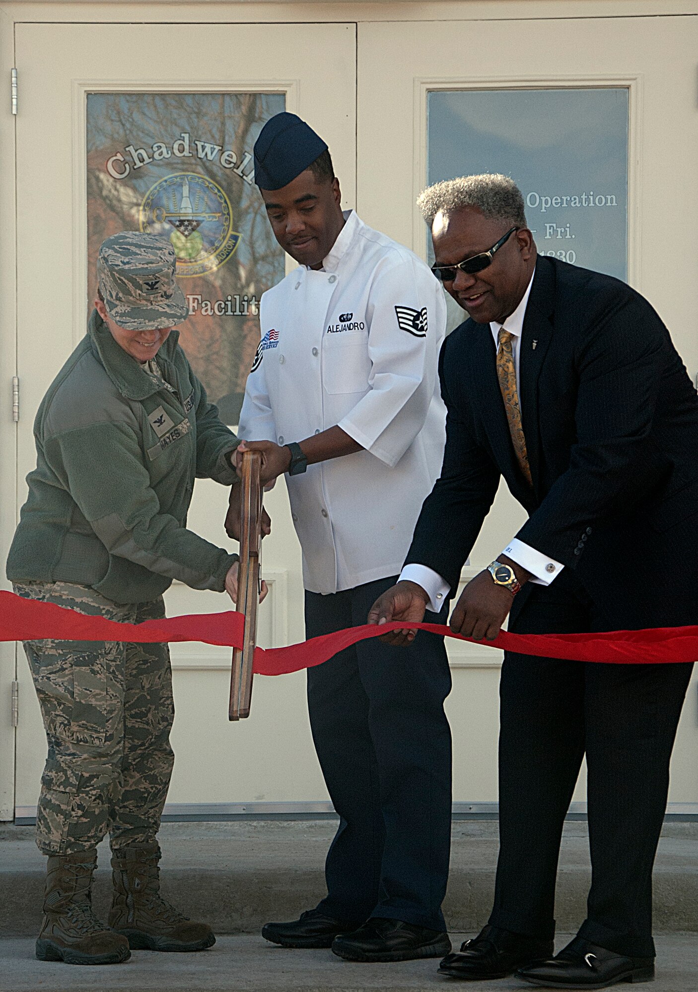 Col. Tracey Hayes, 90th Missile Wing commander; Staff Sgt. Dexter Alejandro, 90th Force Support Squadron; and H.L. Larry, Deputy Director of Air Force Services; cut a ribbon during the Chadwell Dining Facility grand opening Nov. 21,2014, on F.E. Warren Air Force Base, Wyo. The DFAC provides healthy food options for all military ranks, family members, retirees and civilians on base. (U.S. Air Force photo/Airman 1st Class Brandon Valle)