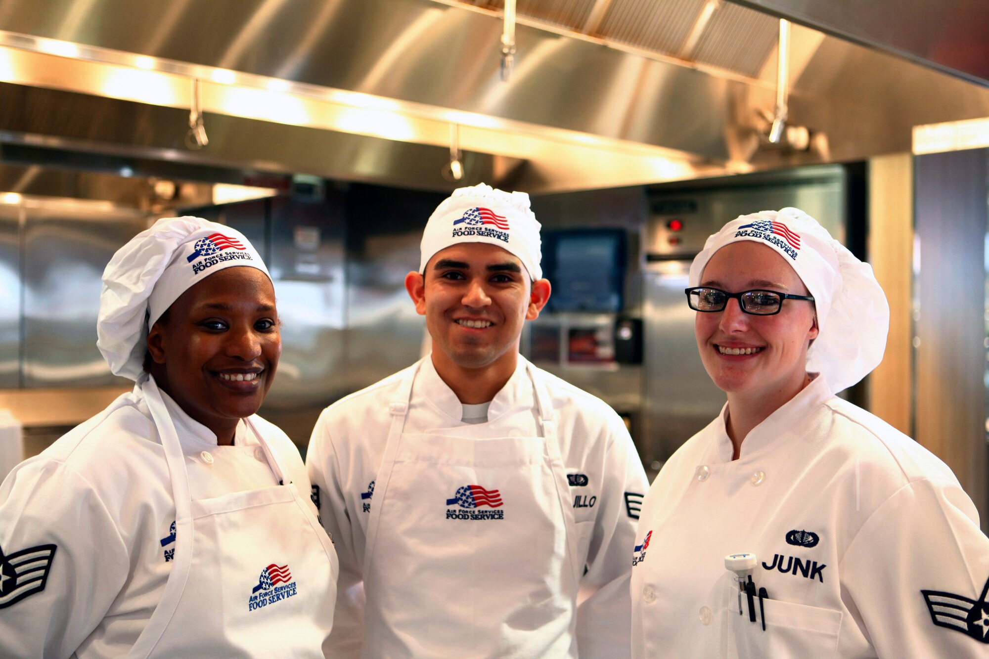 Staff Sgt. Michele Morris and Senior Airmen Florentine Trujillo and Brittany Junk, 90th Force Support Squadron, pose for a photo during the Chadwell Dining Facility grand opening Nov. 21, 2014, on F.E. Warren Air Force Base, Wyo. The facility includes a pizza grill, a deli and panini bar, U-food station, Mongolian Grill and smoothie bar. (U.S. Air Force photo/Lan Kim)