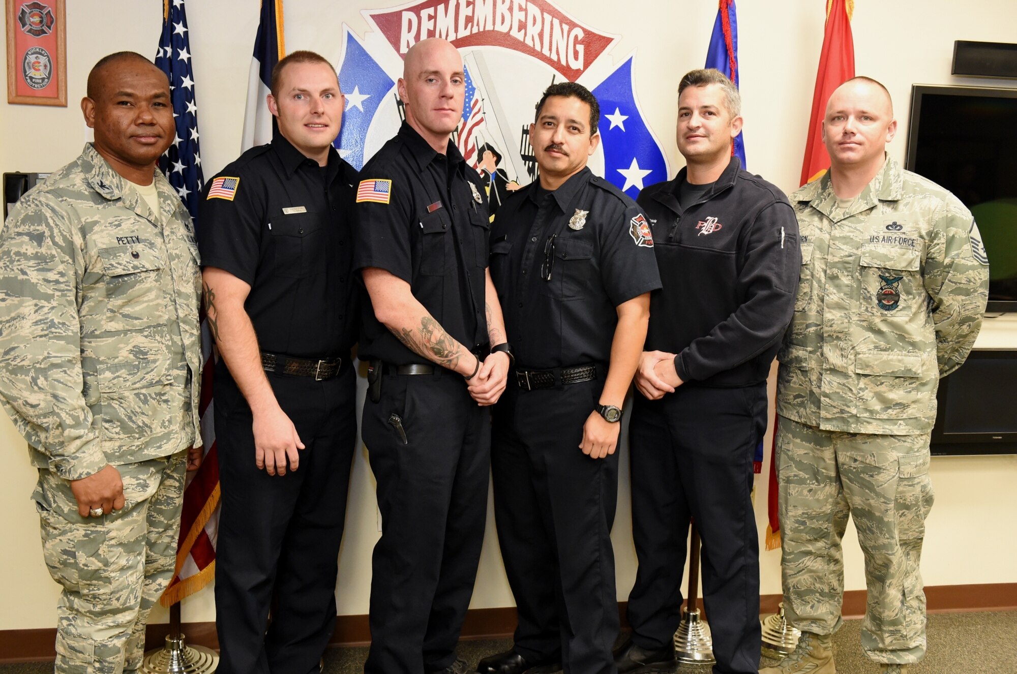 Col. George Petty, Air Force Space Command Civil Engineer Readiness and Emergency Management chief, left, and Master Sgt. Jayme Scammerhorn, AFSPC command fire chief, right, congratulated four Team Buckley firefighters with the AFSPC Fire Emergency Services Save Certificate Nov. 20, 2014, at the fire department on Buckley Air Force Base, Colo. Recipients of the certificate were, from second to left, Brandon Elson, Kenneth Bradley, Carlos Hidalgo and Joseph Boscia. The four firefighters received the award for their lifesaving actions while responding to a major vehicle accident in October 2014. (U.S. Air Force photo by Tech. Sgt. Kali L. Gradishar/Released)