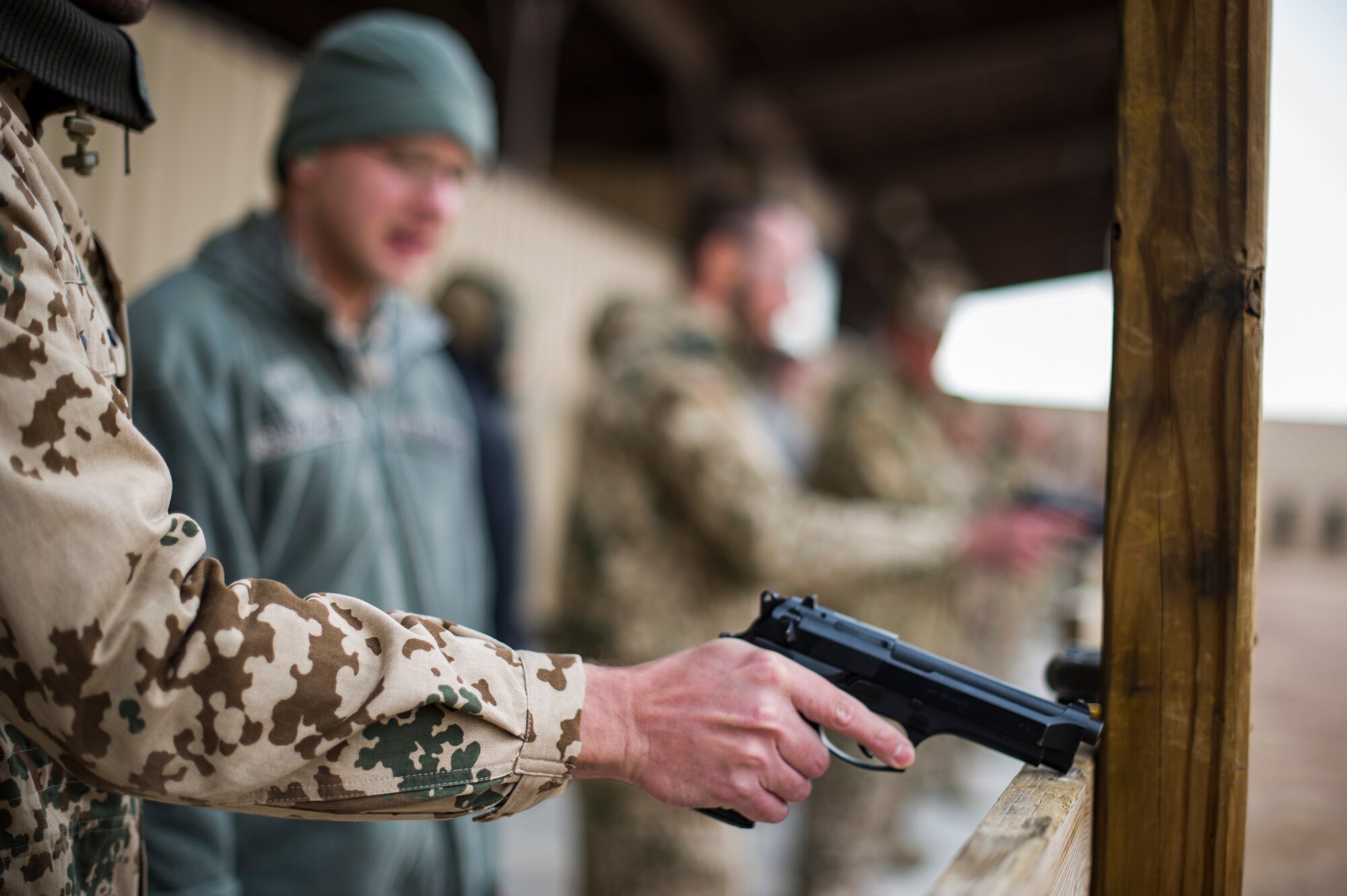 A member of the German Air Force prepares to fire a M-9 Pistol during a shooting event at Holloman Air Force Base, N.M., Nov. 12.  Holloman Airmen and the German Air Force came together at the Combat Arms and Maintenance facility to enhance squadron camaraderie. Each country had an opportunity to fire each other’s weapons with the chance of earning the Air Force Marksmanship Ribbon, or the German Air Force Marksmanship Badge, Schutzenschnur. (U.S. Air Force photo by Airman 1st Class Aaron Montoya/released)