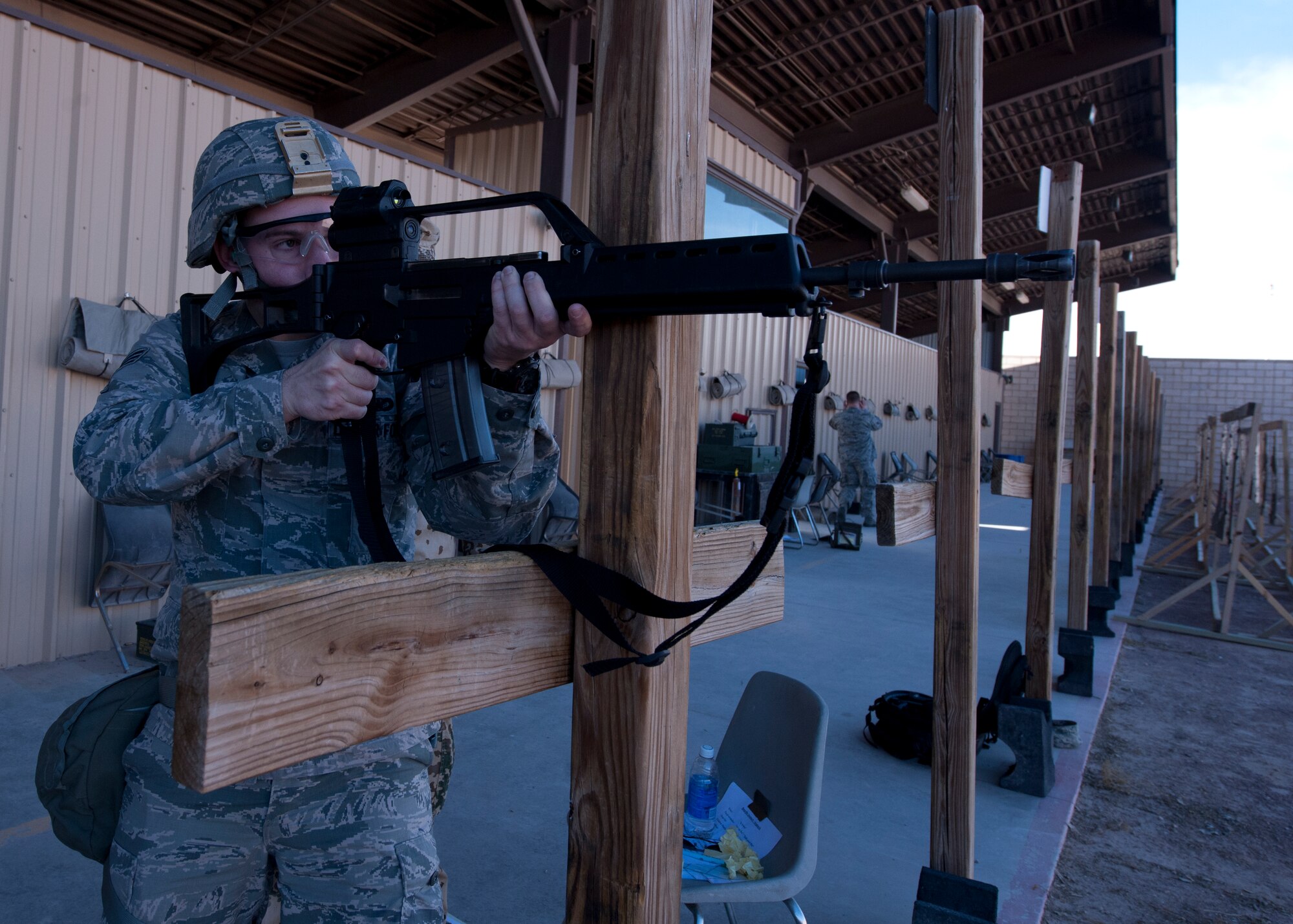 Senior Airman Alex Moore, 49th Security Forces Squadron patrolman prepares to qualify during a teambuilding event at Holloman Air Force Base, N.M., Nov. 12. The event was held at the Combat Arms and Maintenance facility, and brought together the German Air Force and the Holloman Security Forces Squadron for some old-fashioned camaraderie. The event allowed Airmen from each Air Force to qualify on the other’s weapons. Holloman Airmen had the opportunity to shoot the G36 Assault Rifle and the P8 Pistol, while the German Air Force qualified on the M-4 Rifle and M-9 Pistol. (U.S. Air Force photo by Senior Airman Leah Ferrante/released)