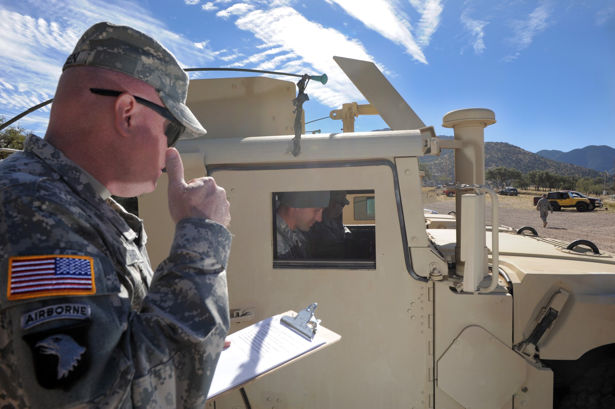 U.S. Army Staff Sgt. Charles Harden, 304th Bravo Company instructor and course writer, teaches Airmen how to properly respond to a roadside improvised explosive device during the Army Weather Support Course at Fort Huachuca, Ariz., Nov. 19, 2014. The primary objective of the training is to make certain the Airmen were able to properly perform an unexploded ordnance report. (U.S. Air Force photo by Airman 1st Class Chris Drzazgowski/Released)
