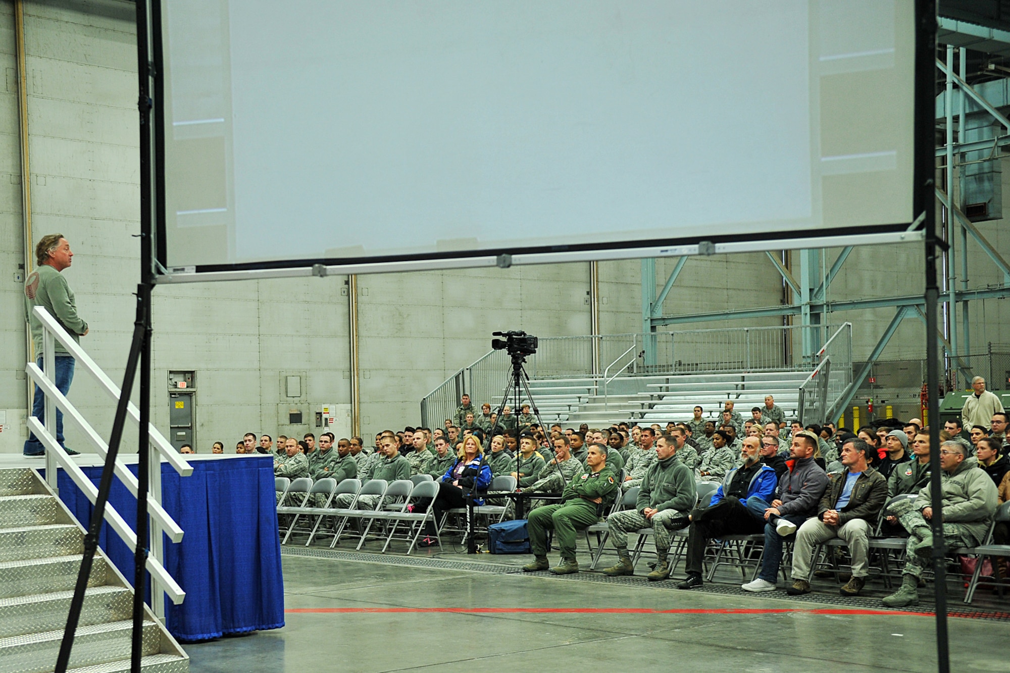 Coach Greg Glassman, founder and chief executive officer of CrossFit, addresses Team Offutt members during his brief in the Bennie Davis Maintenance Facility, Offutt Air Force Base, Nov. 12. During his brief, Glassman spoke about how he started CrossFit, overall fitness and why it’s important, and how CrossFit helps prepare one for life changes, something military members deal with during their careers. (U.S. Air Force photo by Charles Haymond/Released)