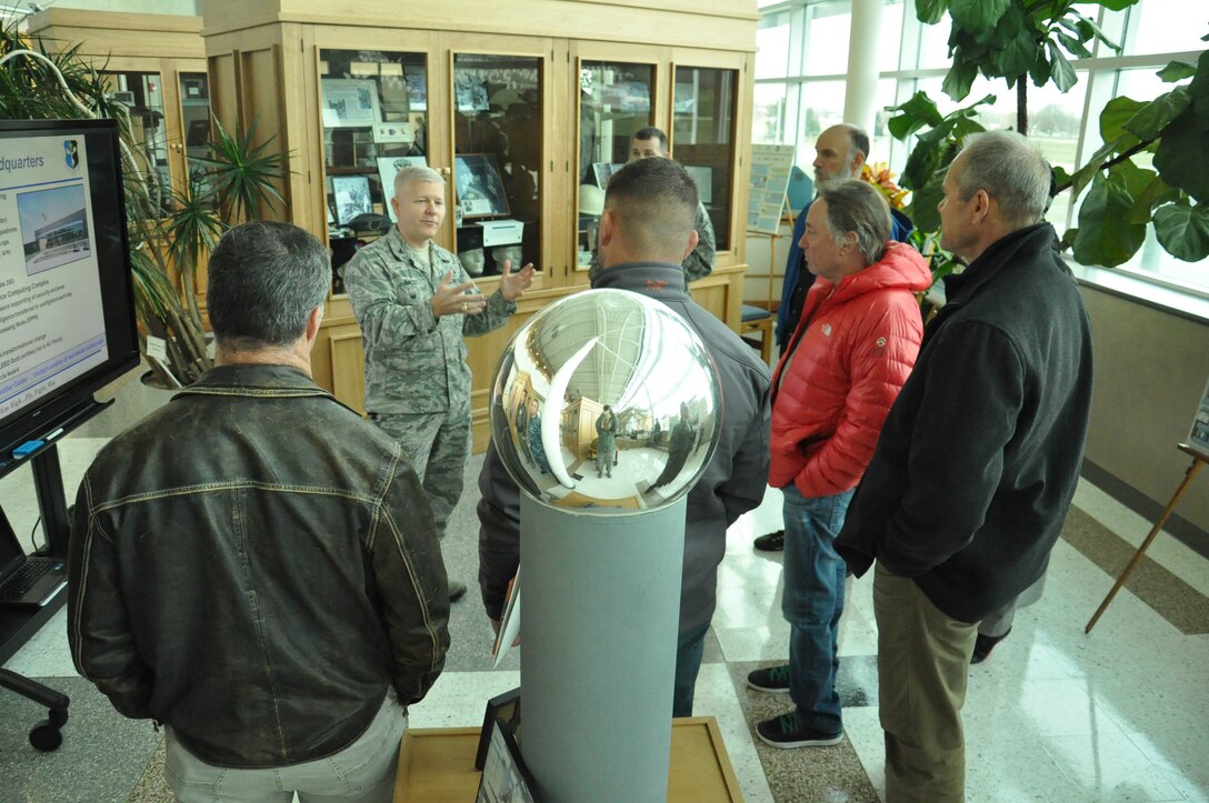 U.S. Air Force Col. David Bacot, Air Force Weather Agency vice commander, speaks with Coach Greg Glassman, founder and chief executive officer of CrossFit, and his team in the AFWA headquarters, Offutt Air Force Base, Nov. 12. Glassman also spoke with base leadership about how exercise not only helps one be fit, it can also help people mentally, benefiting military members when they are down range, at a desk, or at home. (U.S. Air Force photo by 2nd Lt. Carly A. Costello/Released)