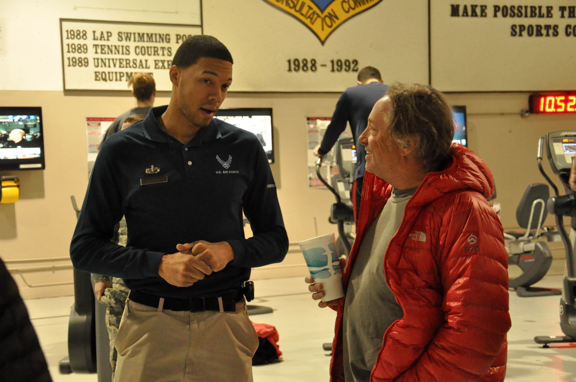 Coach Greg Glassman, founder and chief executive officer of CrossFit, speaks with U.S. Air Force Tech. Sgt. Terrell Costa, NCO in charge of the Offutt Fitness Center, during a tour of the Offutt Field House Nov. 12. CrossFit has found a home in the military and law enforcement communities since its creation in 2000. (U.S. Air Force photo by 2nd Lt. Carly A. Costello/Released)