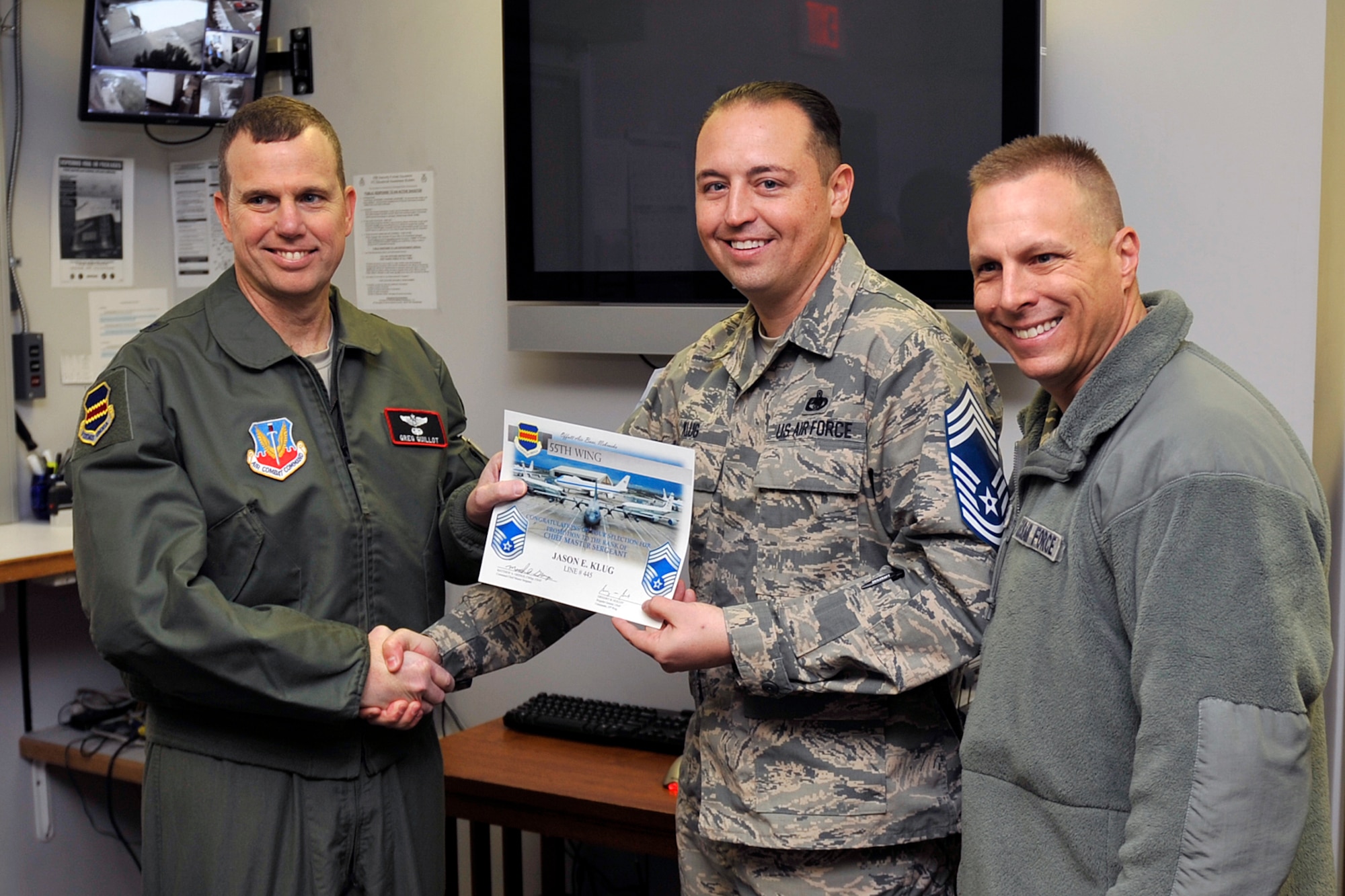 U.S. Air Force Senior Master Sgt. Jason Klug, 55th wing security manager, is presented a certificate for his accomplishment. U.S. Air Force Brig. Gen. Gregory Guillot, 55th Wing commander, and U.S. Air Force Chief Master Sgt. Matthew Grengs, 55th Wing command chief, on being one of nine Team Offutt senior master sergeants selected for promotion to chief as announced by Air Force Personnel Center officials Nov. 20. Air Force-wide, 479 senior master sergeants were selected out of 2,525 eligible for an 18.97 percent selection rate, according to AFPC. (U.S. Air Force photo by Jeff W. Gates/Released)