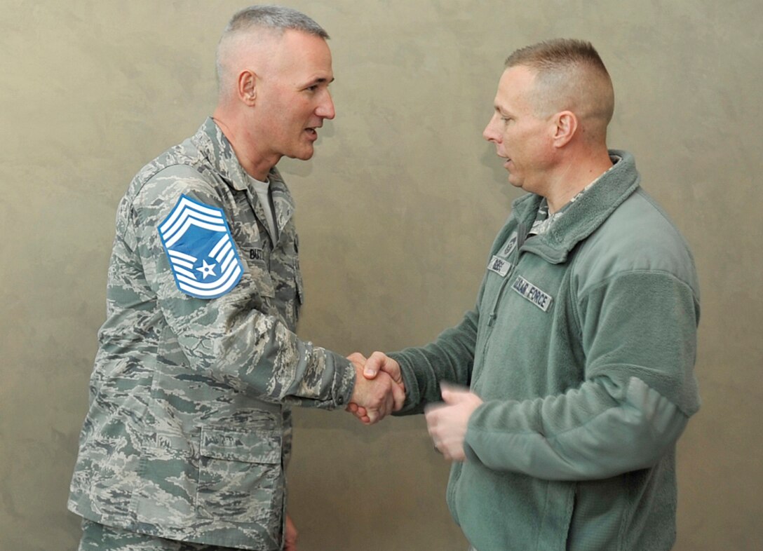 U.S. Air Force Senior Master Sgt. Scott Butler, Air Force Weather Agency, is congratulated by U.S. Air Force Chief Master Sgt. Matthew Grengs, 55th Wing Command Chief, on being one of nine Team Offutt senior master sergeants selected for promotion to chief as announced by Air Force Personnel Center officials Nov. 20. Air Force-wide, 479 senior master sergeants were selected out of 2,525 eligible for an 18.97 percent selection rate, according to AFPC. (U.S. Air Force photo by Jeff W. Gates/Released)