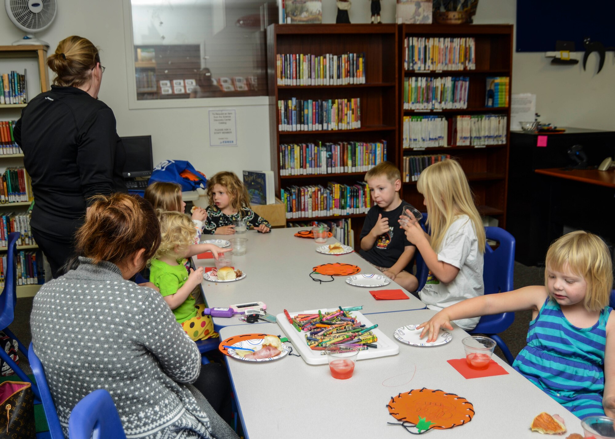 At the book reading, AFRC staff and volunteers helped the children with a fall craft and served them a mini-Thanksgiving meal. (U.S. Air Force photo by Rebecca Amber)