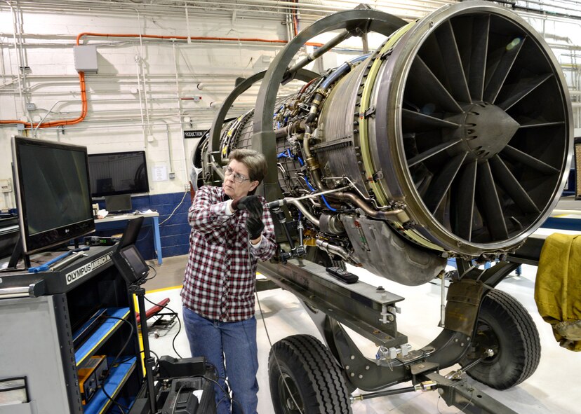 Jo Harris, with the 76th Propulsion Maintenance Group, uses a boroscope to look for damaged blades, veins or FOD inside of an F110 engine. A video boroscope is a valuable tool when a mechanic needs to see hard-to-reach places inside of an engine. The user inserts a camera into the engine and can inspect the inside by seeing it on a monitor instead of having to tear-down the engine. (Air Force photo by Kelly White)