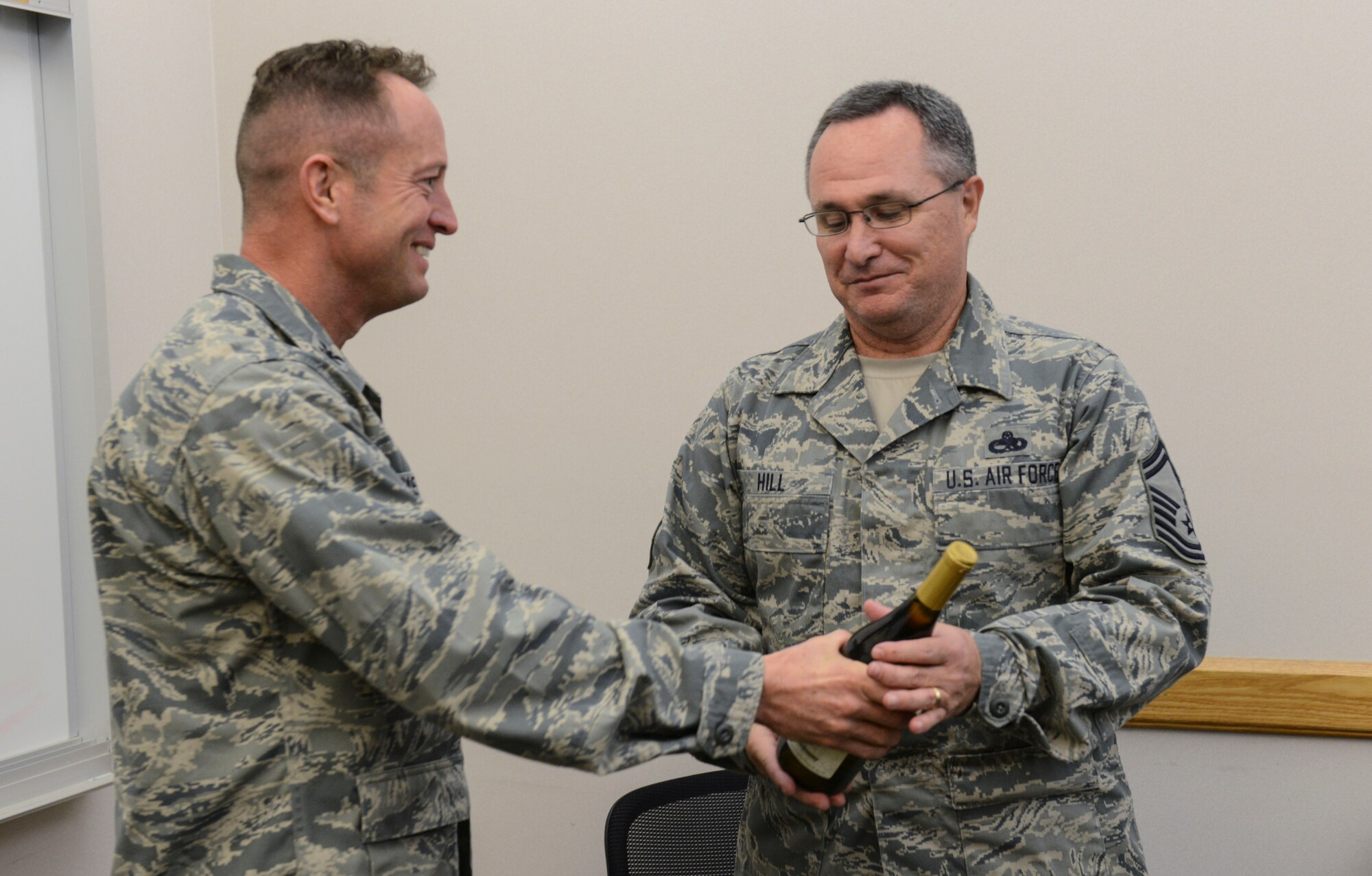 Col. David Iverson, 366th Fighter Wing commander, congratulates Senior Master Sgt. Robert Hill, 366th Component Maintenance Squadron assistant maintenance superintendent, Nov. 20, 2014, at Mountain Home Air Force Base, Idaho. The chief master sergeant selects had an opportunity to get to know chiefs from across base at a breakfast the following day. (U.S. Air Force photo by Airman 1st Class Malissa Lott/RELEASED)