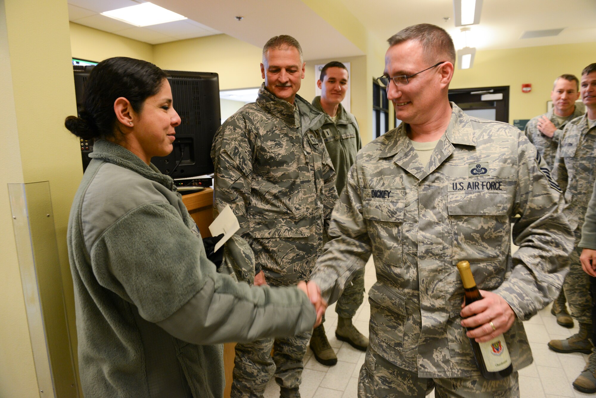 Chief Master Sgt. Sandra Nunes, 366th Medical Group chief, congratulates Senior Master Sgt. Robert Dickey, 366th Operations Support Squadron air field manager, Nov. 20, 2014, at Mountain Home Air Force Base, Idaho. Col. David Iverson, 366th Fighter Wing commander, along with squadron commanders and chiefs, visited each selectee at his or her squadron. (U.S. Air Force photo by Airman 1st Class Malissa Lott/RELEASED)
