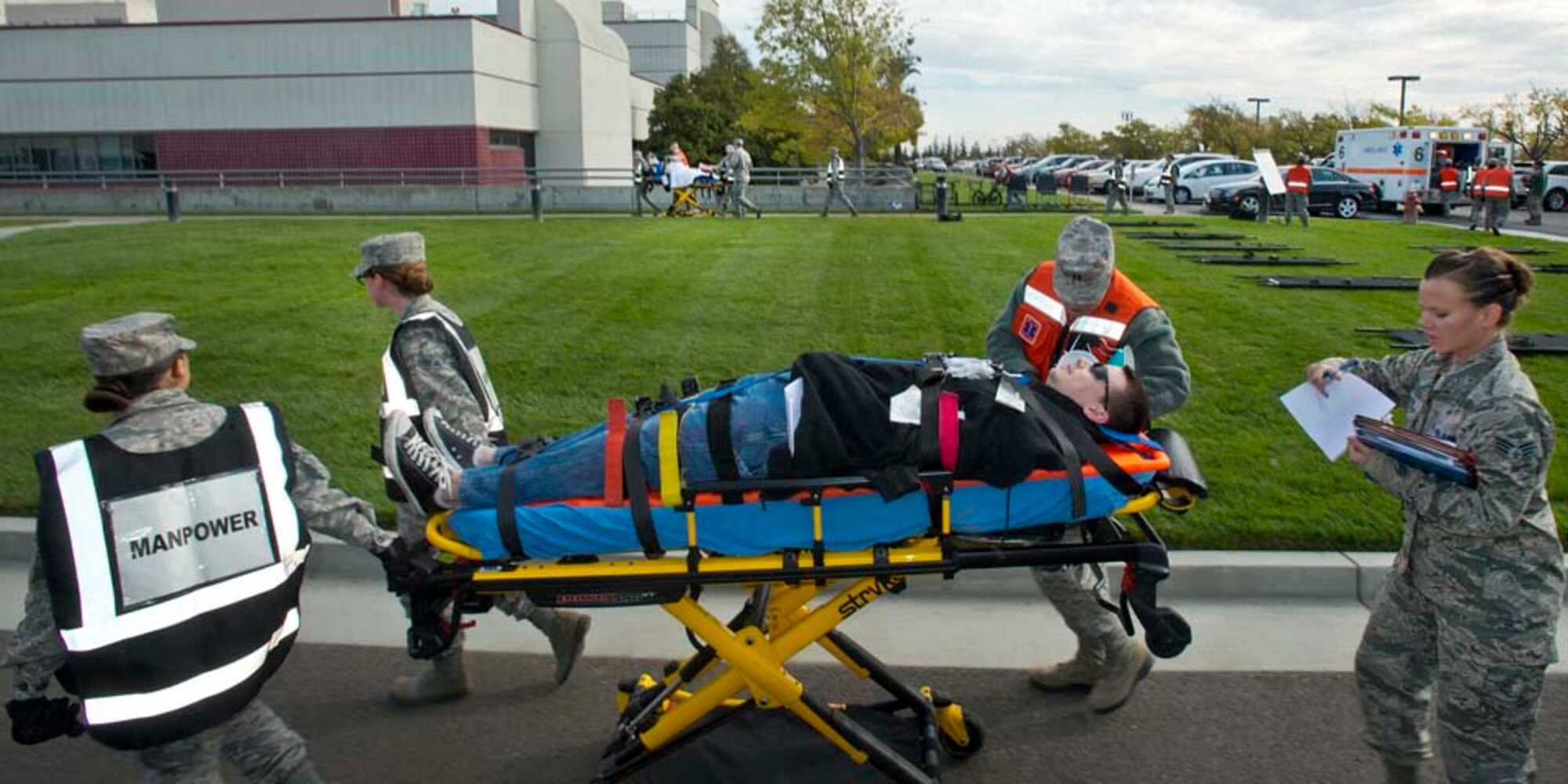 Airmen from the 60th Medical Group transport a simulated victim during an active-shooter exercise Nov. 18, 2014, at Travis Air Force Base, California. (U.S. Air Force photo by T.C. Perkins Jr.)