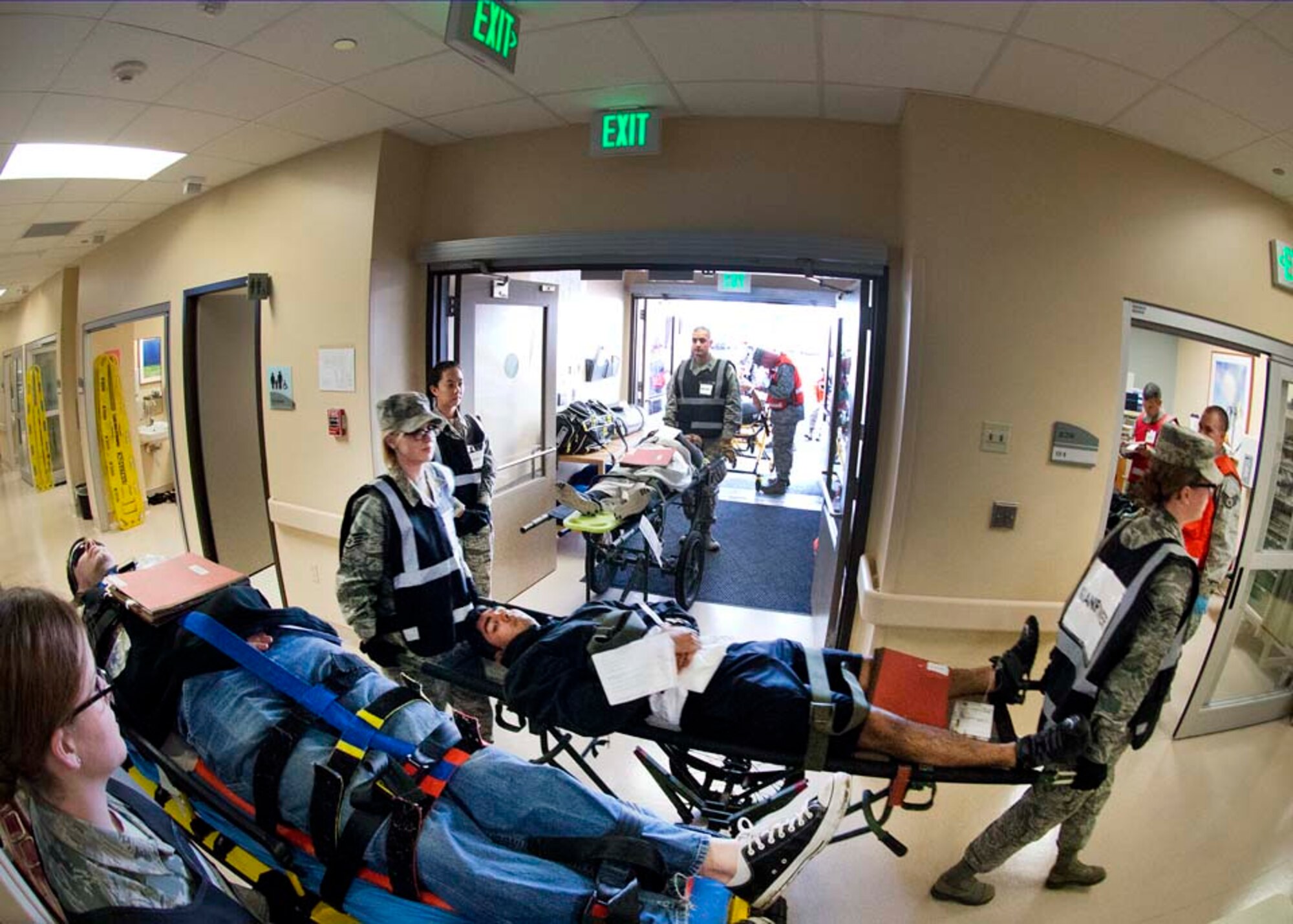 Airmen from the 60th Medical Group transport a simulated victim during an active-shooter exercise Nov. 18, 2014, at Travis Air Force Base, California. (U.S. Air Force photo by T.C. Perkins Jr.)