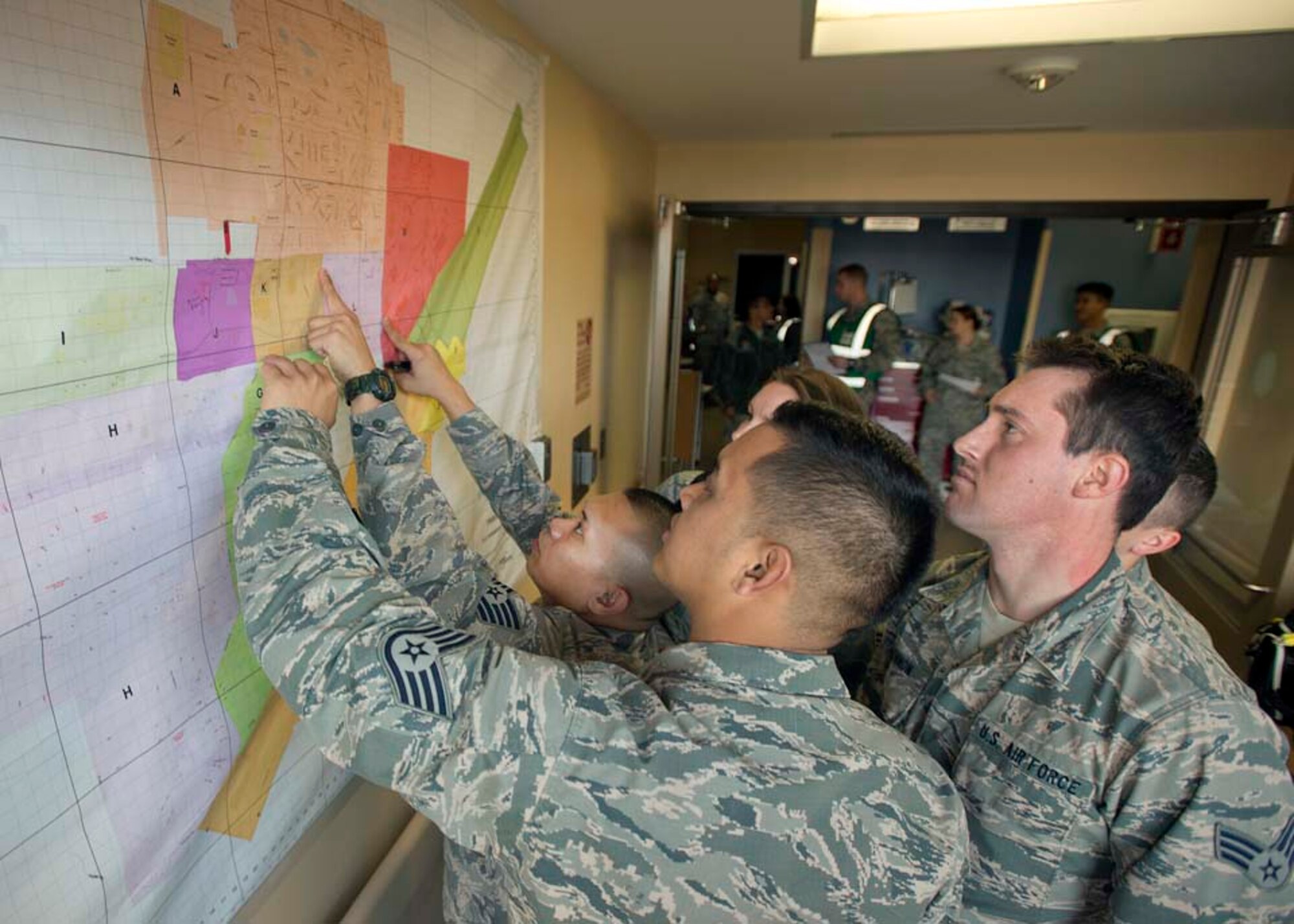 Travis emergency room personnel try to locate an area on a map of the installation during an active-shooter exercise Nov. 18, 2014, at Travis Air Force Base, California. The active-shooter exercise evaluated base first responders abilities to manage a mass casualty incident. (U.S. Air Force photo by T.C. Perkins Jr.)