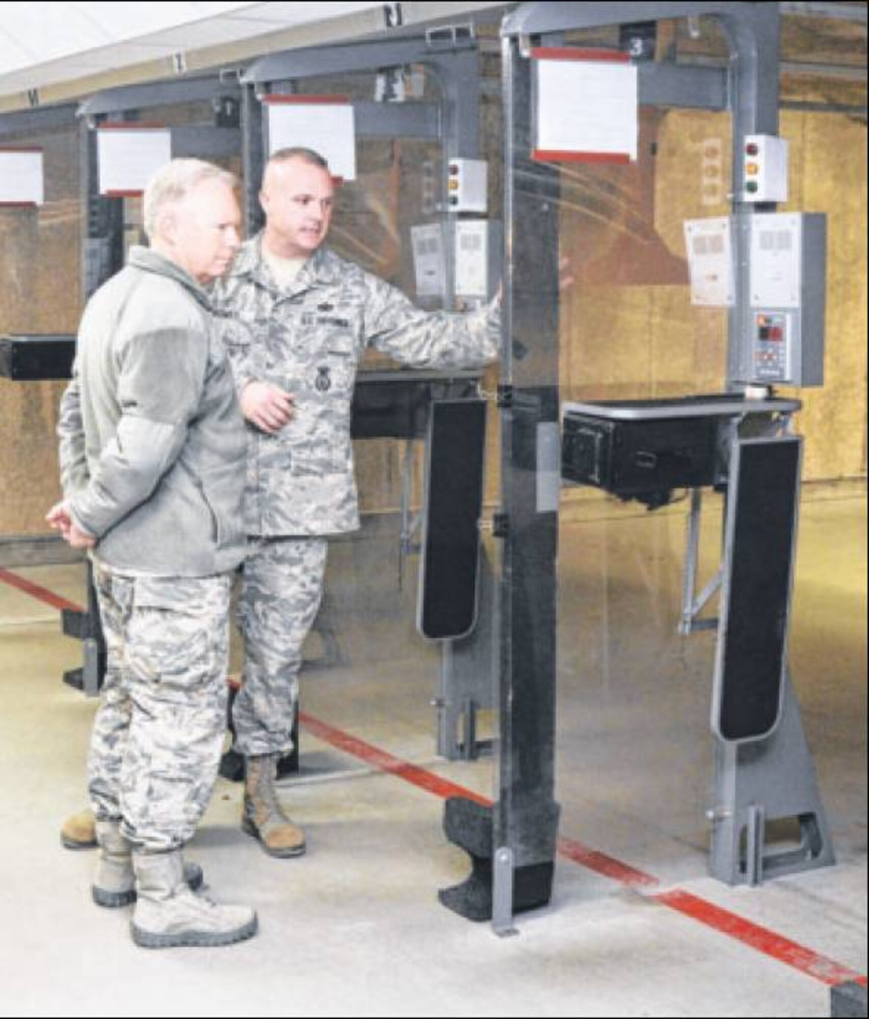 Sgt Bowes shows Lt. Gen. Thompson the indoor firing range and explains the uses of the range for different weapons during the general's visit. (Air Force Photos by Wesley Farnsworth)