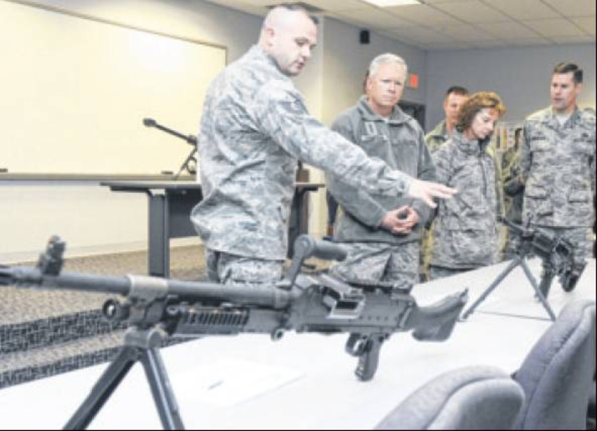 Tech. Sgt Sean Bowes, 88th Security Forces Squadron Combat Army Training and Maintainance (CATM) non-commissioned officer in charge, shows Lt. Gen. John Thompson, Air Force Life Cycle Management Center commander, some of the various weapons the base has access to during Thompson's tour of the 88th Air Base Wing on Nov. 13. Other stops included the Kittyhawk Pharmacy, 88th Operations Support Squadron, 88th Medical Group, the 88th Communications Group and the base recycling center. Looking on during the CATM stop are Chief Master Sgt. Doreen Losacco, AFLCMC commnad chief, Chief Master Sgt. Charles Hoffman, 88th ABW command chief, and Col. John Devillier, 88th ABW commander. (Air Force Photos by Wesley Farnsworth)