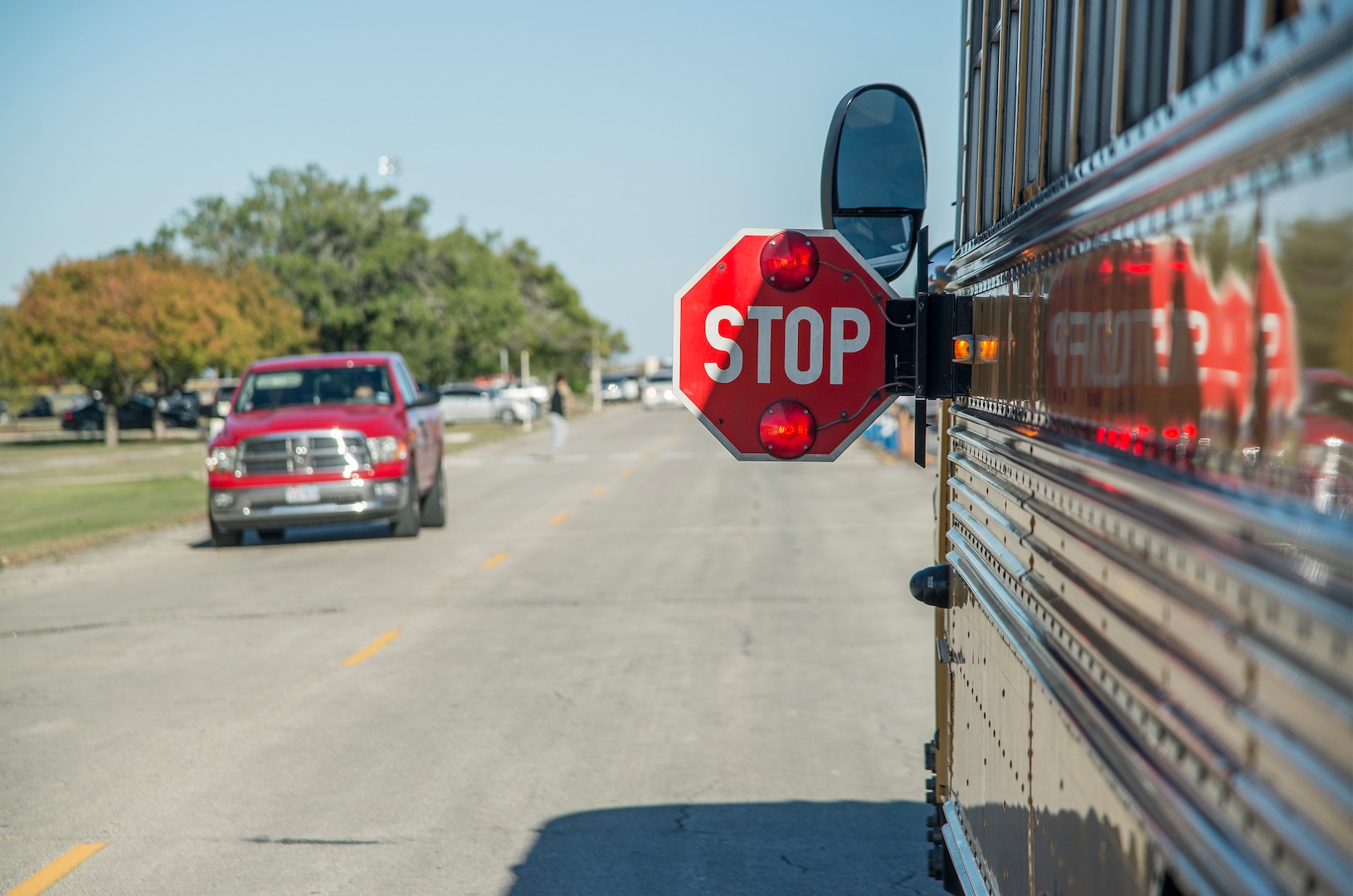 The 902nd Security Forces Squadron is stepping up its patrols because of speeding problems that pose safety risks to children boarding school buses at Joint Base San Antonio, Texas.  School buses use yellow flashing lights to alert motorists that they are preparing to stop to load or unload children. Red flashing lights and an extended stop sign signals to motorists that the bus is stopped and children are getting on or off the bus. It is illegal in any state to pass a school bus that is stopped to load or unload children. In addition to this, drivers are urged to always watch for children crossing traffic lanes, observe school zone speed limits, instructions of crossing guards and use caution when traveling through school zones or near routes used by children. 