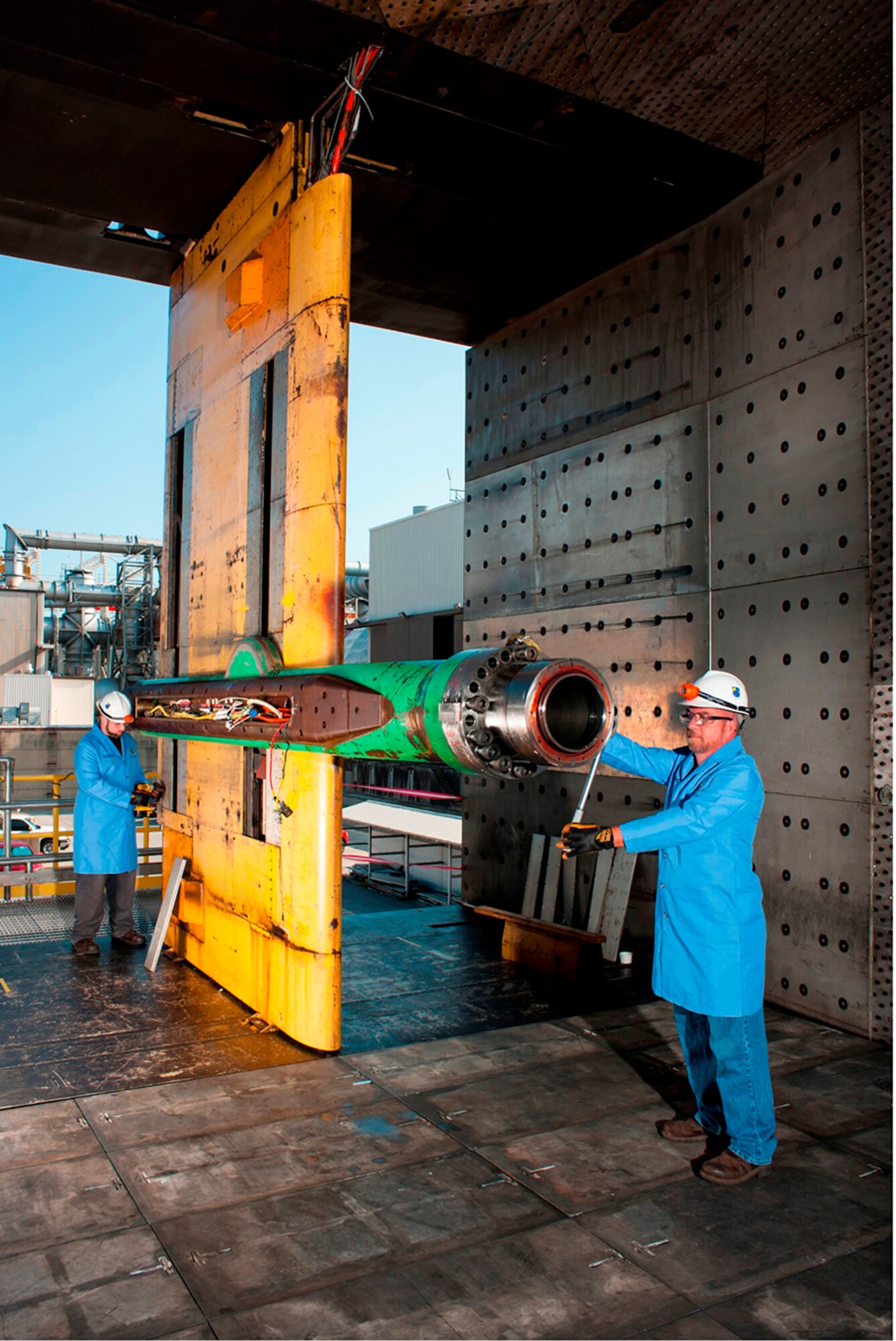 Aaron Blaser and Christian Morris, outside machinists, assist in the reactivation of the 16T Pitch Boom. (Photo by Rick Goodfriend)