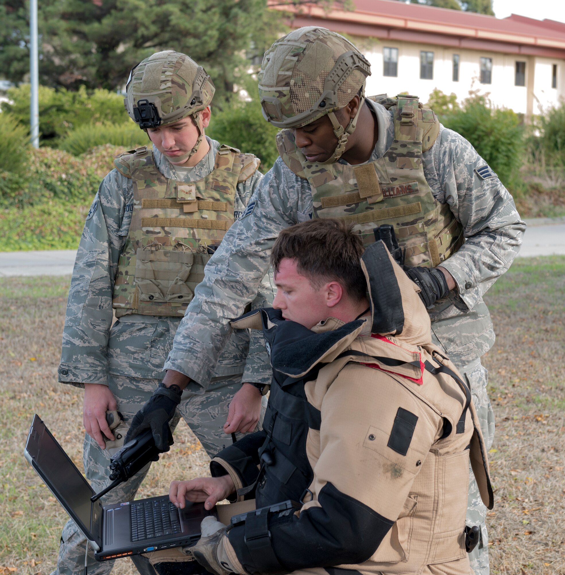 Travis Explosive Ordnance Disposal specialists prepare to evaluate a possible incendiary device that was left in an abandoned building during a base wide exercise Nov. 18, 2014, at Travis Air Force Base, California. The base wide scenario was played out in realistic, gritty detail, all in an effort to prepare emergency personnel and all Travis AFB employees for a potential crisis. (U.S. Air Force photo by Heide Couch)