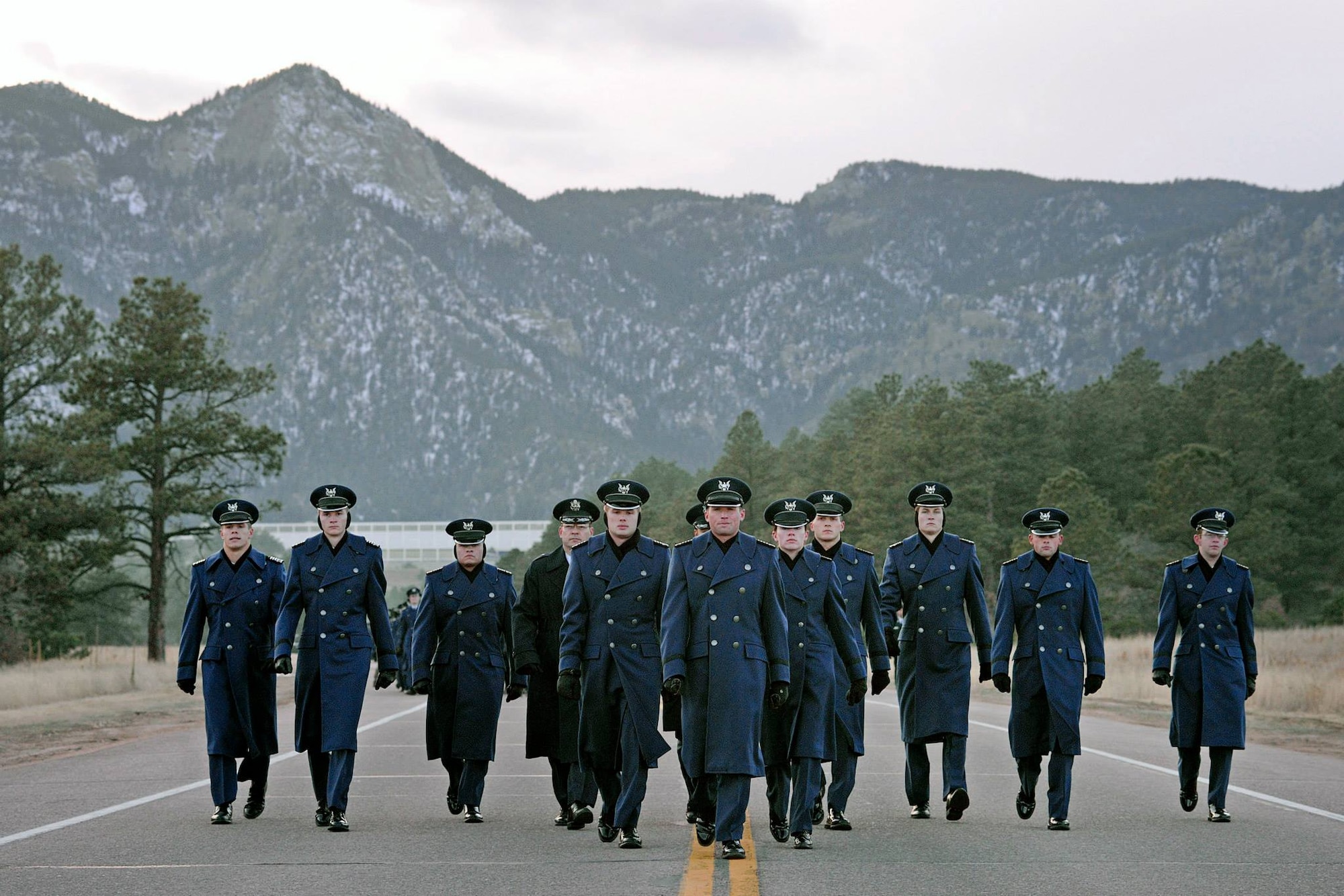 Academy cadets march from the Cadet Wing to the cemetery Nov. 14, 2014, in recognition of Heritage Weekend, which honors the history of the Academy and the Airmen who came before them. The march culminated in the laying of heritage emblems on the graves, and a discussion of the lives of the Airmen buried there. (U.S. Air Force photo/Mike Kaplan)
