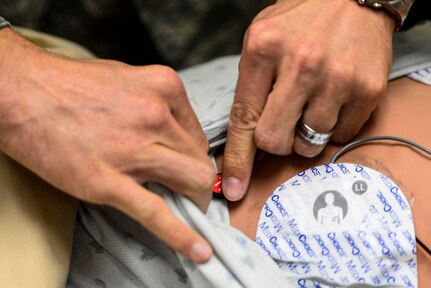 A U.S. Air Force Service member prepares to administer an electrocardiogram during a lifesaver training at Langley Air Force Base, Va., Nov. 19, 2014. Members of the 633rd Medical Group education and training office at USAF Hospital Langley are responsible for providing the most current training practices so that individuals attending courses can return to their units with elevated skills and knowledge. (U.S. Air Force photo by Senior Airman Kayla Newman/Released)