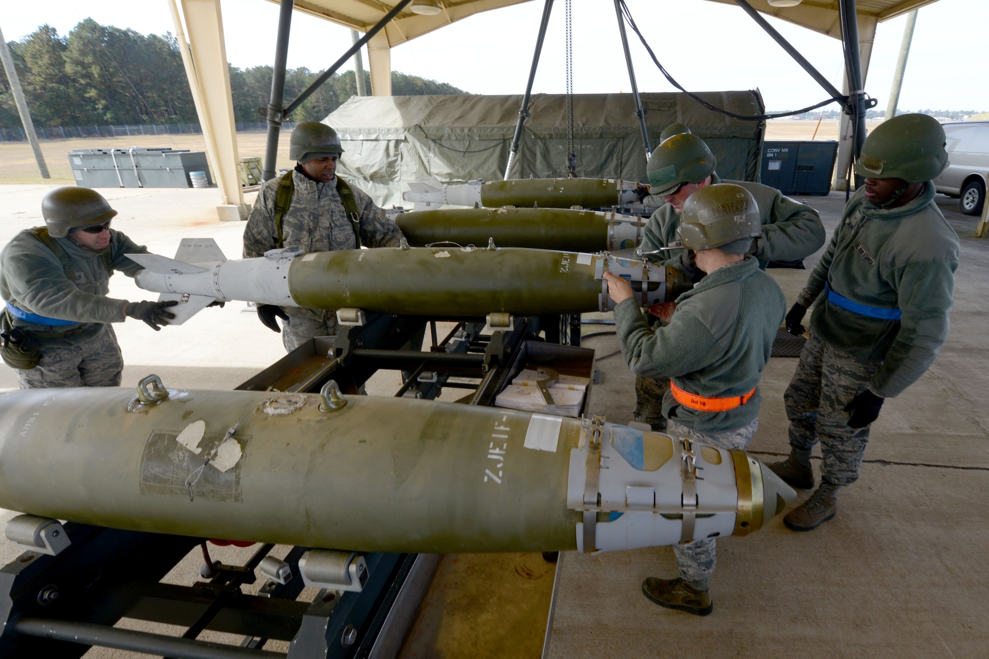 U.S. Air Force Tech. Sgt. Tony McKay, 20th Equipment Maintenance Squadron munitions flight munitions support equipment maintainer, tightens an arming wire on a MK-82 missile during a bomb build exercise at Shaw Air Force Base, S.C., Nov. 19, 2014. When the missile is dropped from an airplane and hits the ground, three explosions take place within the missile when it detonates. (U.S. Air Force photo by Senior Airman Ashley L. Gardner/Released)