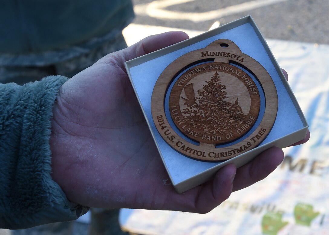 Col. Daniel Waters, 11th Wing commander, holds a Christmas tree ornament at the 2014 U.S. Capitol Christmas Tree arrival on Joint Base Andrews, Md., Nov. 20, 2014. Chippewa National Forrest members gave out ornaments while thanking military members and their families for their service. (U.S. Air Force photo/ Senior Airman Nesha Humes)