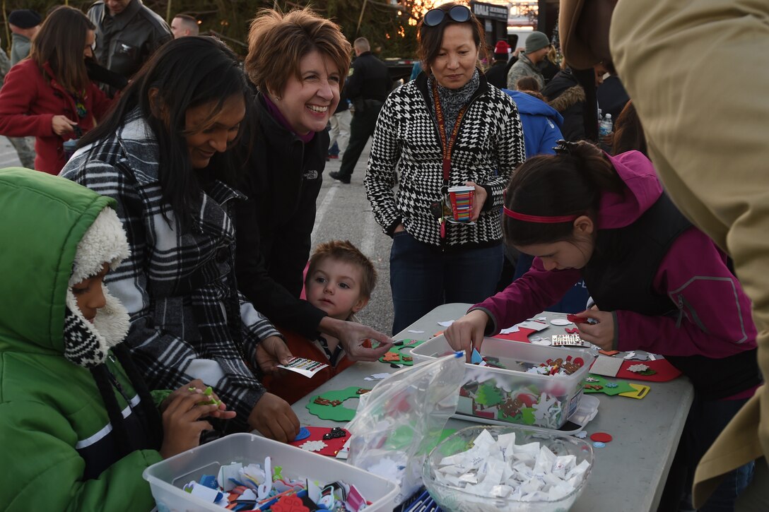 Attendees of the 2014 U.S. Capitol Christmas Tree arrival make arts and crafts at an event stand on Joint Base Andrews, Md., Nov. 20, 2014. The 88-year old white spruce made its final stop at JBA in its 2,000 mile road trip before it will be displayed and lit at the U.S. Capitol Building’s west lawn on Dec. 2. (U.S. Air Force photo/ Senior Airman Nesha Humes)