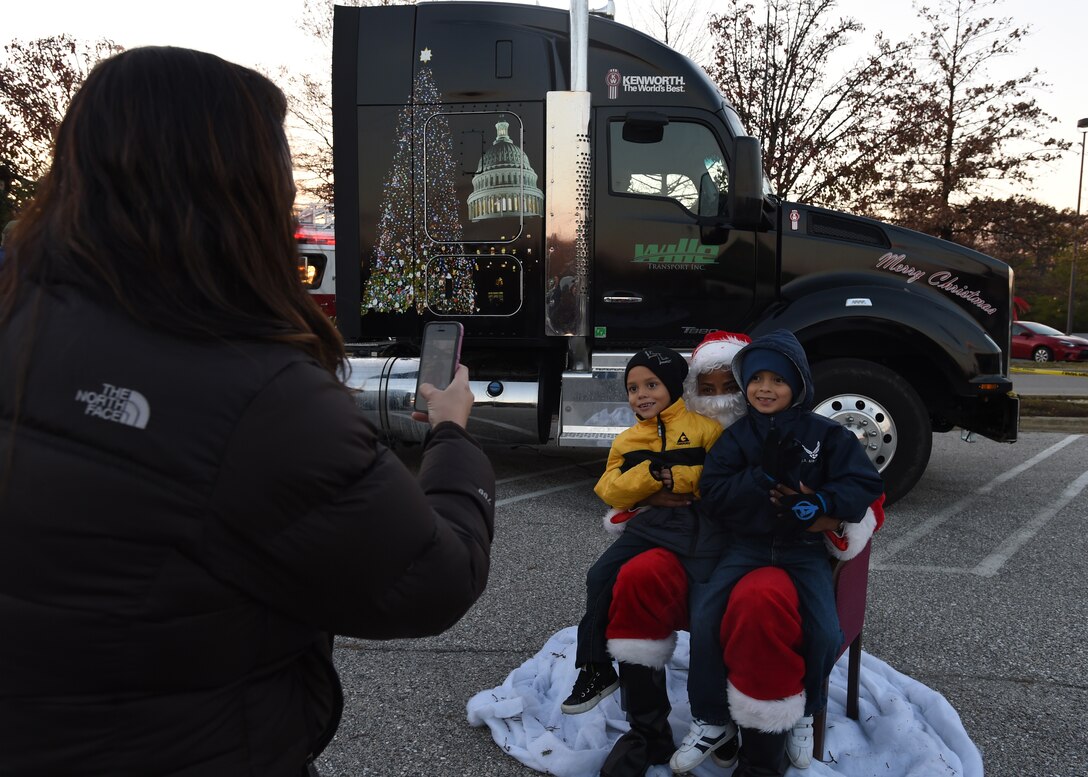 Attendees of the 2014 U.S. Capitol Christmas Tree arrival take a photo with Santa Clause on Joint Base Andrews, Md., Nov. 20, 2014. The tree made its final stop at JBA in its 2,000 mile road trip before it will be displayed and lit at the U.S. Capitol Building’s west lawn on Dec. 2. (U.S. Air Force photo/ Senior Airman Nesha Humes)