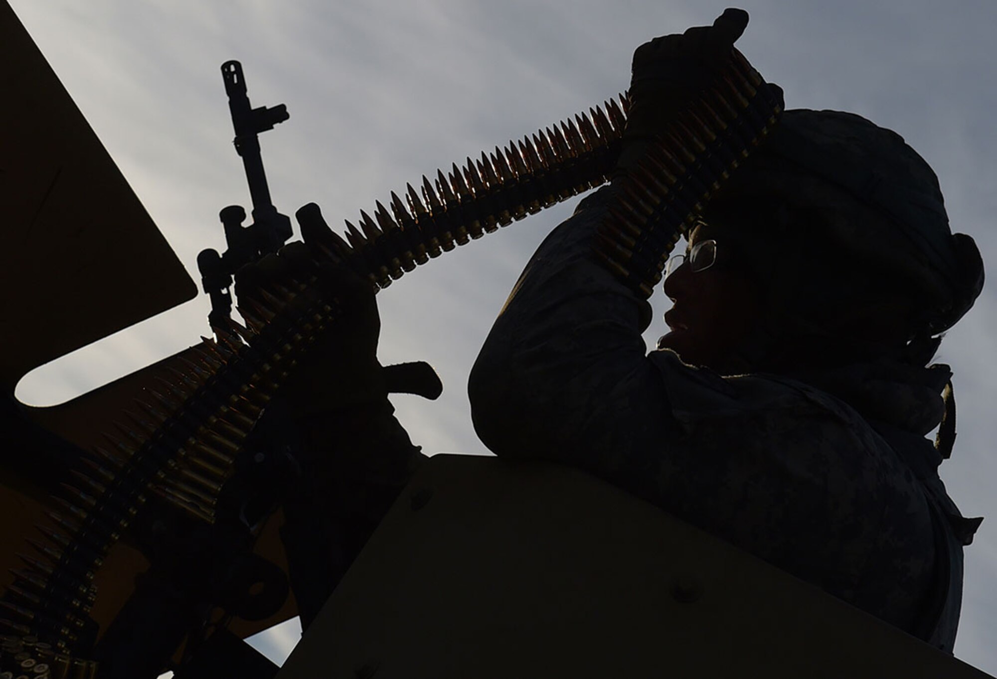 A Soldier assigned to U.S. Army Alaska's 109th Transportation Company loads his M240B machine gun, Friday, Nov. 14, 2014, on Joint Base Elmendorf-Richardson, Alaska, in preparation for a convoy live-fire exercise. The transportation soldiers also simultaneously executed react-to-ambush procedures with follow-on hasty and deliberate vehicle recovery operations.  (U.S. Air Force photo/Justin Connaher)