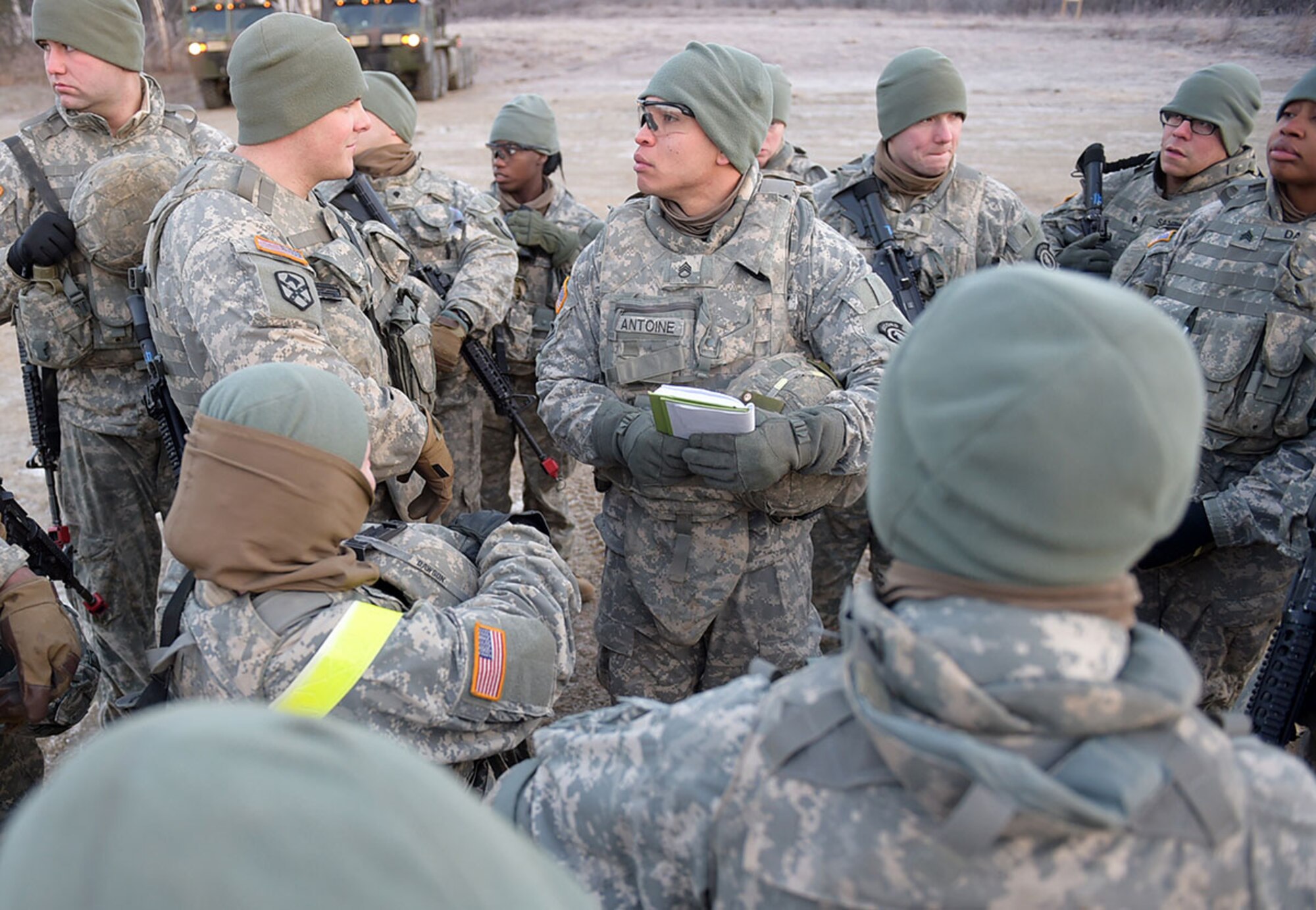 Army Staff Sgt. Jovan Antoine briefs his Soldiers in preparation for a convoy live-fire exercise, Friday, Nov. 14, 2014, on Joint Base Elmendorf-Richardson, Alaska. The soldiers, assigned to U.S. Army Alaska's 109th Transportation Company, also executed react-to-ambush procedures with follow-on hasty and deliberate vehicle recovery operations.  (U.S. Air Force photo/Justin Connaher)