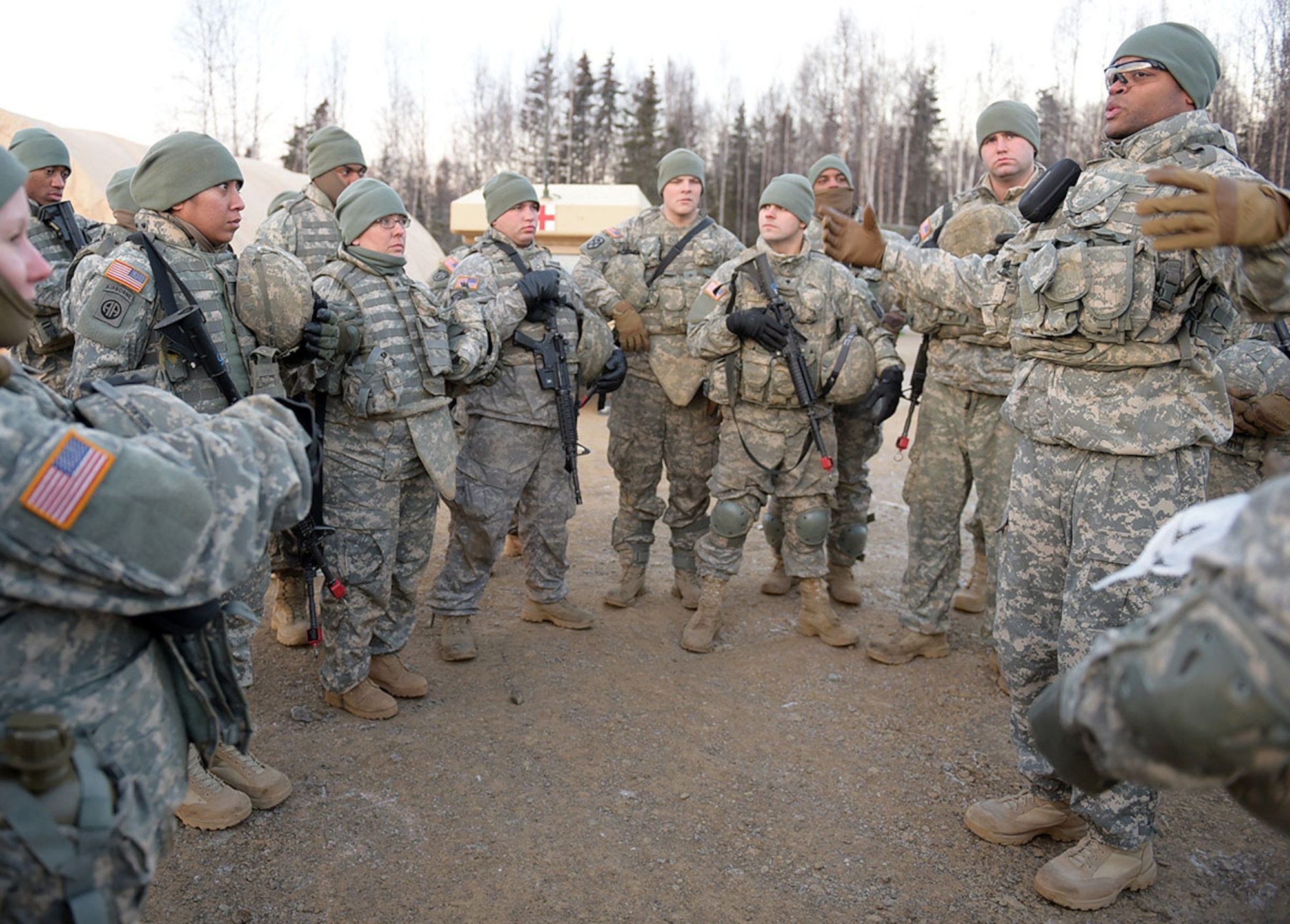 Army 2nd Lt. Herman Tisdale, a native of Charleston, S.C., briefs Soldiers in preparation for a convoy live-fire exercise, Friday, Nov. 14, 2014, on Joint Base Elmendorf-Richardson, Alaska. The soldiers, assigned to U.S. Army Alaska's 109th Transportation Company, also executed react-to-ambush procedures with follow-on hasty and deliberate vehicle recovery operations. (U.S. Air Force photo/Justin Connaher)