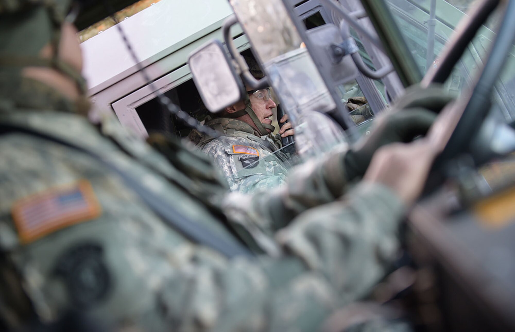 A Soldier assigned to U.S. Army Alaska's 109th Transportation Company makes a radio call for a vehicle recovery, Thursday, Nov. 13, 2014, on Joint Base Elmendorf-Richardson, Alaska, after a simulated enemy ambush.  (U.S. Air Force photo/Justin Connaher)
