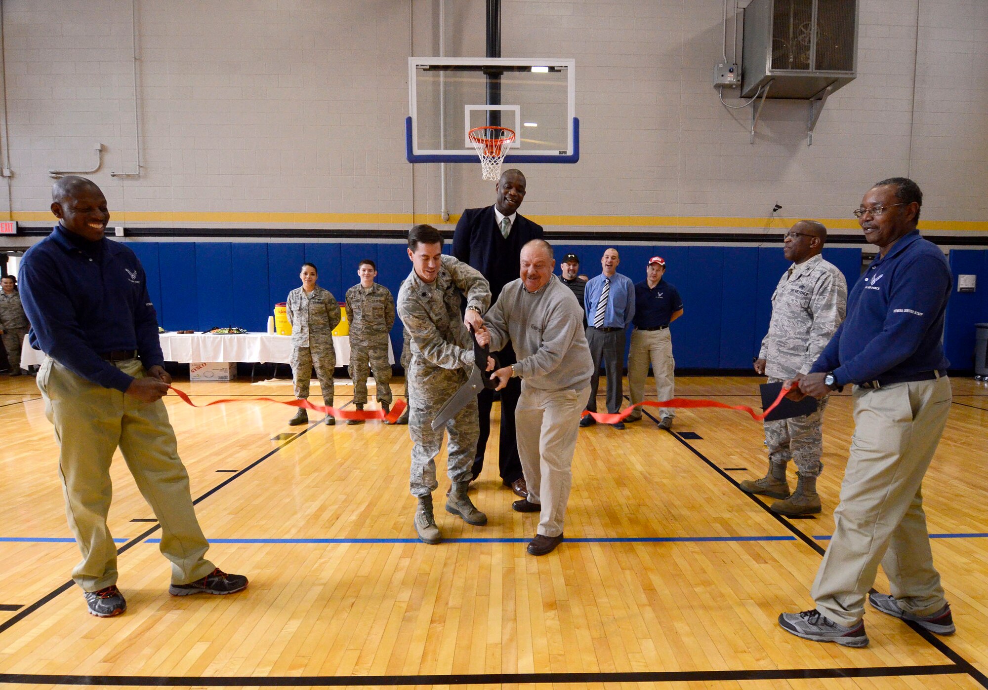 A ribbon is cut signaling the opening of the newly renovated fitness center at Dobbins Air Reserve Base, Ga. Nov. 18, 2014. The fitness center includes approximately 30 new pieces of equipment. (U.S. Air Force photo by Don Peek/Released)