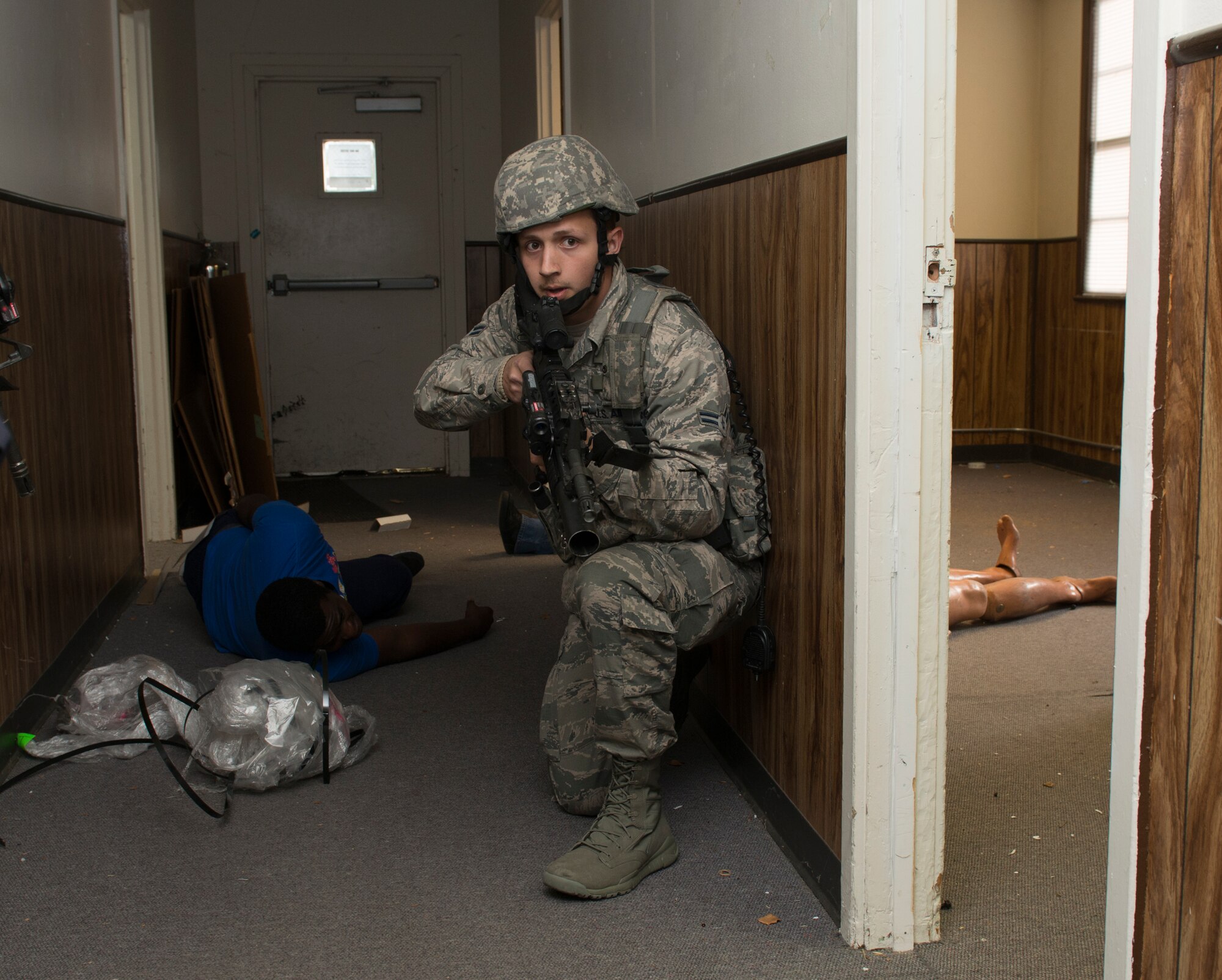An Airman from the 60th Security Forces Squadron enters a vacant building during a simulated active-shooter scenario Nov. 18, 2014, at Travis Air Force Base, California. The Airmen effectively neutralized the shooter and secured the facility. To ensure safety during the exercise, the Airmen traded their real firearms for training weapons. Travis routinely conducts emergency exercises to prepare the base for possible threats, natural disasters and accidents. (U.S. Air Force photo by Heide Couch)