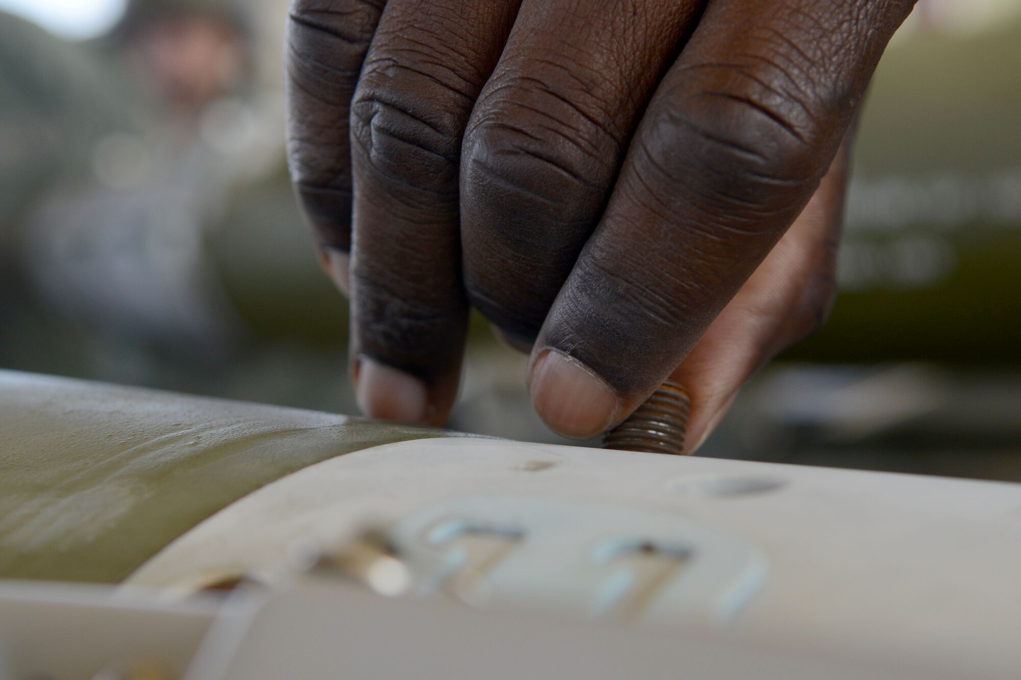 U.S. Air Force Airman 1st Class Xavier Jeffers, 20th Equipment Maintenance Squadron munitions flight munitions support equipment maintainer, tightens a screw on a MK-82 missile during a bomb build at Shaw Air Force Base, S.C., Nov. 19, 2014. 20th EMS Airmen are in charge of making sure the bomb is properly put together and all appropriate wires are connected. (U.S. Air Force photo by Senior Airman Ashley L. Gardner/Released)