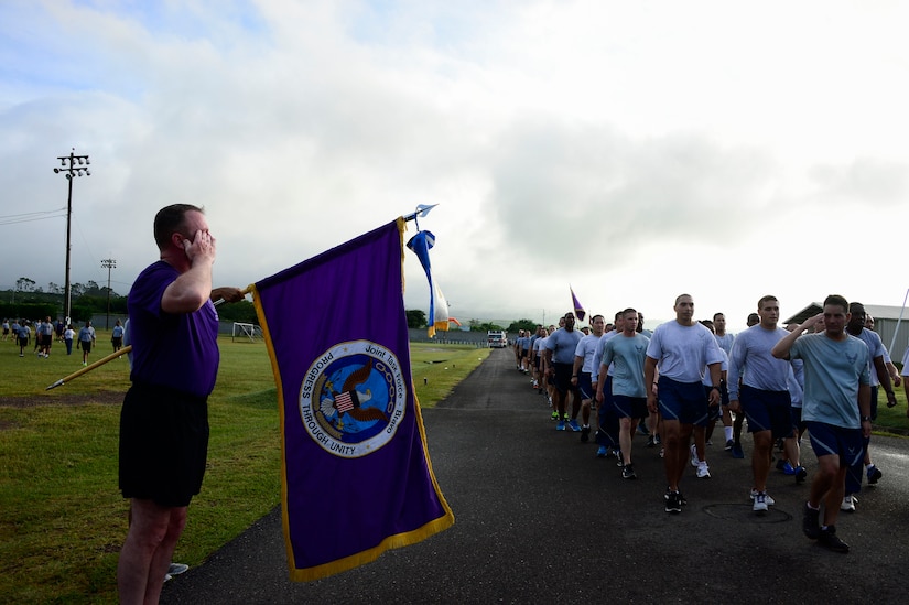 U.S. Army Col. Kirk Dorr, Joint Task Force-Bravo commander, salutes each of the major subordinate commands as they finish the quarterly JTF-Bravo four-mile run at Soto Cano Air Base, Honduras, Nov. 21, 2014.  Once a quarter JTF-Bravo holds a formation run to encourage esprit de corps and physical fitness. (U.S. Air Force photo/Tech. Sgt. Heather Redman)