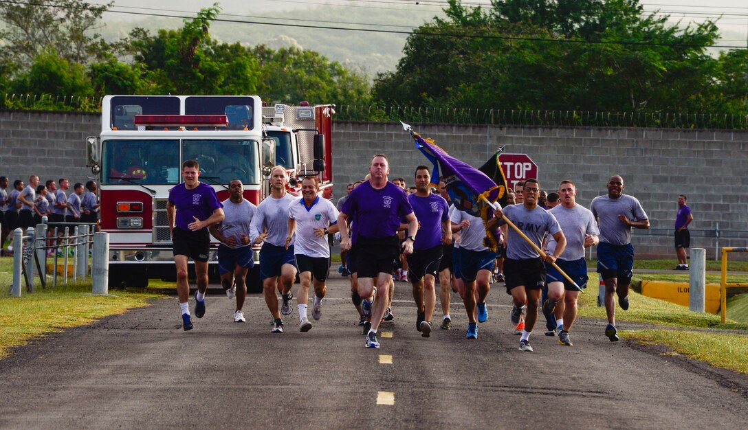 U.S. Army Col. Kirk Dorr, Joint Task Force-Bravo commander, leads the formation in a sprint to the finish during the quarterly JTF-Bravo four-mile run at Soto Cano Air Base, Honduras, Nov. 21, 2014.  Once a quarter JTF-Bravo holds a formation run to encourage esprit de corps and physical fitness. (U.S. Air Force photo/Tech. Sgt. Heather Redman)