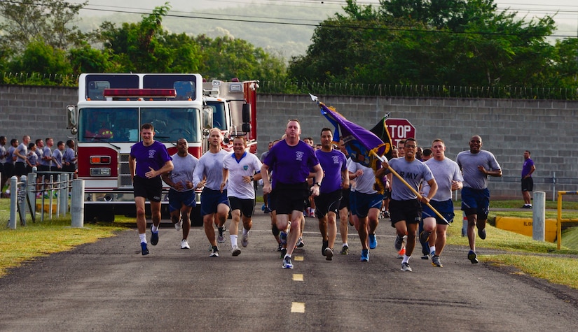 U.S. Army Col. Kirk Dorr, Joint Task Force-Bravo commander, leads the formation in a sprint to the finish during the quarterly JTF-Bravo four-mile run at Soto Cano Air Base, Honduras, Nov. 21, 2014.  Once a quarter JTF-Bravo holds a formation run to encourage esprit de corps and physical fitness. (U.S. Air Force photo/Tech. Sgt. Heather Redman)