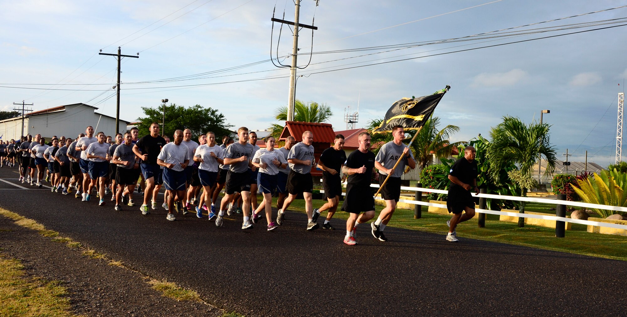 Members of Joint Task Force-Bravo run in formation during the quarterly JTF-Bravo four-mile run at Soto Cano Air Base, Honduras, Nov. 21, 2014.  Once a quarter JTF-Bravo holds a formation run to encourage esprit de corps and physical fitness. (U.S. Air Force photo/Tech. Sgt. Heather Redman)