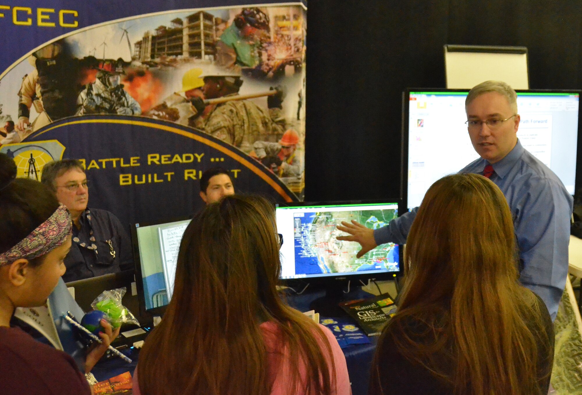Scott Ensign shows the many different uses for Geospatial Integrated Systems technology to students during Alamo Area GIS Day Nov. 14 in San Antonio. The event gave the students an opportunity to learn about career opportunities and see how GIS technology impacts day-to-day life. Ensign is the geospatial integration officer with AFCEC’s Planning and Integration Directorate. (U.S. Air Force photo/Roger Gragg/released)