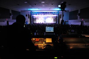 A soundboard technician for the performance troop ,Tops In Blue, monitors the audio equipment during the groups performance at Joint Base Andrews, Md., Nov. 14, 2014. The group performed for a fully packed audience at the base theater. (U.S. Air Force photo/Airman 1st Class Joshua R. M. Dewberry) 
