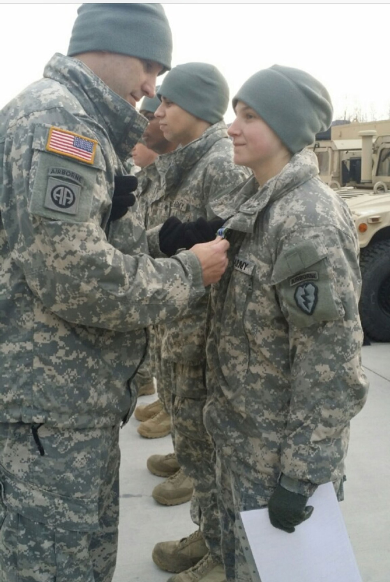 The 725th Brigade Support Battalion (Airborne), 4th Infantry Brigade Combat Team (Airborne), 25th Infantry Division Commander, Lt. Col. Peter Crandall, pins the Army Achievement Medal on Spc. Julieanna Grasser Nov. 17, 2014, during an awards ceremony for her achievement in earning a top spot at the Best Rigger Competition held at Joint Base Elmendorf-Richardson, Alaska. Grasser was one of five riggers selected to represent United States Army Alaska at the 2015 Rigger Rodeo at Fort Bragg, N.C.  (U.S. Army photo by Sgt. Brian Ragin/Released)