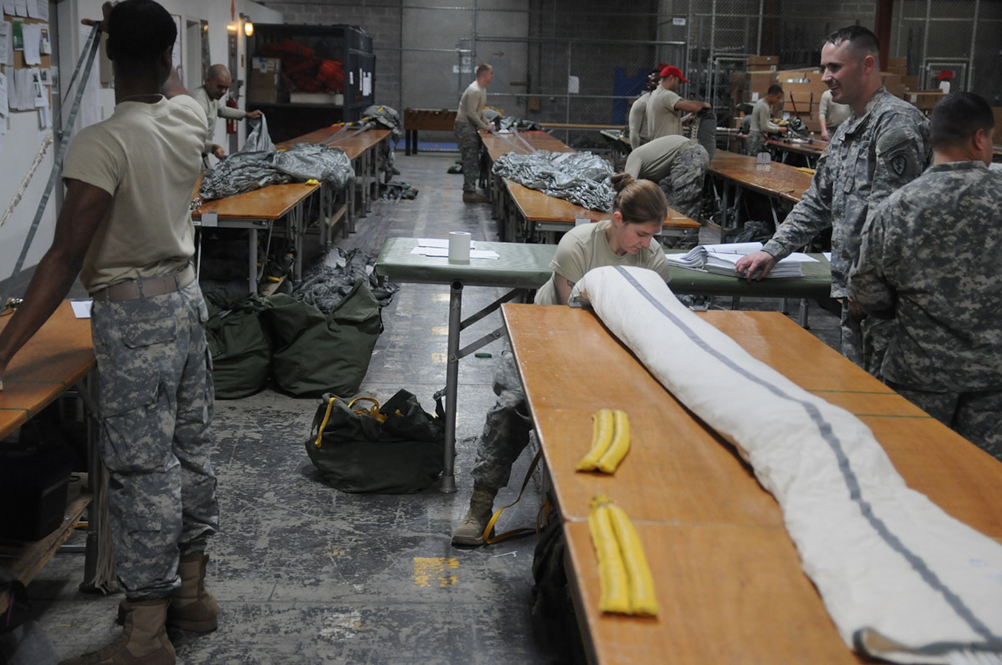 Parachute riggers from the 725th Brigade Support Battalion (Airborne), 4th Infantry Brigade Combat Team (Airborne), 25th Infantry Division, pack T-11 main and reserve personnel parachutes during the Best Rigger Competition at the 4th Quartermaster rigging facility at Joint Base Elmendorf-Richardson, Alaska, Nov. 12, 2014. The top performers from the event will go on to represent U.S. Army Alaska in the upcoming Rigger Rodeo event at Fort Bragg in 2015. (U.S. Army photo by Sgt. Brian Ragin/Released)