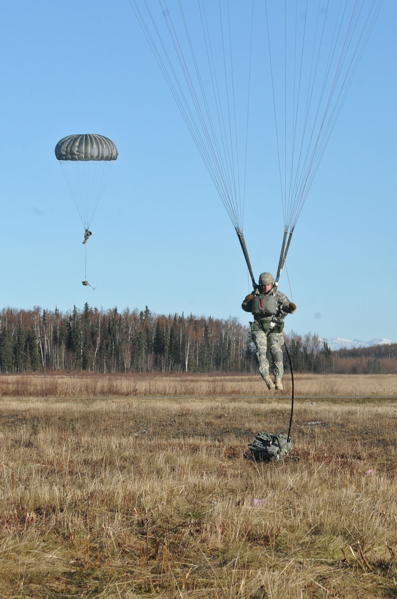 Parachute riggers from the 725th Brigade Support Battalion (Airborne), 4th Infantry Brigade Combat Team (Airborne), 25th Infantry Division, perform precision spot jumps during the first event of the Best Rigger Competition at the Malamute Drop Zone on Joint Base Elmendorf-Richardson, Alaska, Oct. 22, 2014. The riggers packed their own MC-6 parachutes and were timed to get into a certain spot on the drop zone for the competition. The top performers from the event will go on to represent U.S. Army Alaska in the upcoming Rigger Rodeo event at Fort Bragg in 2015. (U.S. Army photo by Sgt. 1st Class Jeffrey Smith/Released)