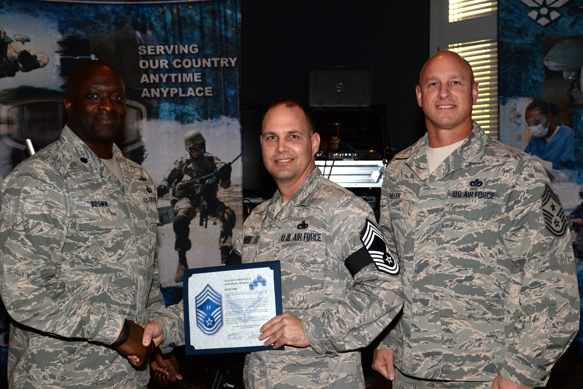 U.S. Air Force Senior Master Sgt. Earle Babb, 495th Fighter Group superintendent, receives his chief master sergeant select promotion certificate from Lt. Col. Thomas Brown, 495th FG deputy commander at Shaw Air Force Base, S.C., Nov. 20, 2014. Babb was one of only three senior master sergeants to earn the rank of chief and those selected will be promoted according to their promotion sequence number beginning in January. (U.S. Air Force photo by Airman 1st Class Jonathan Bass/Released)