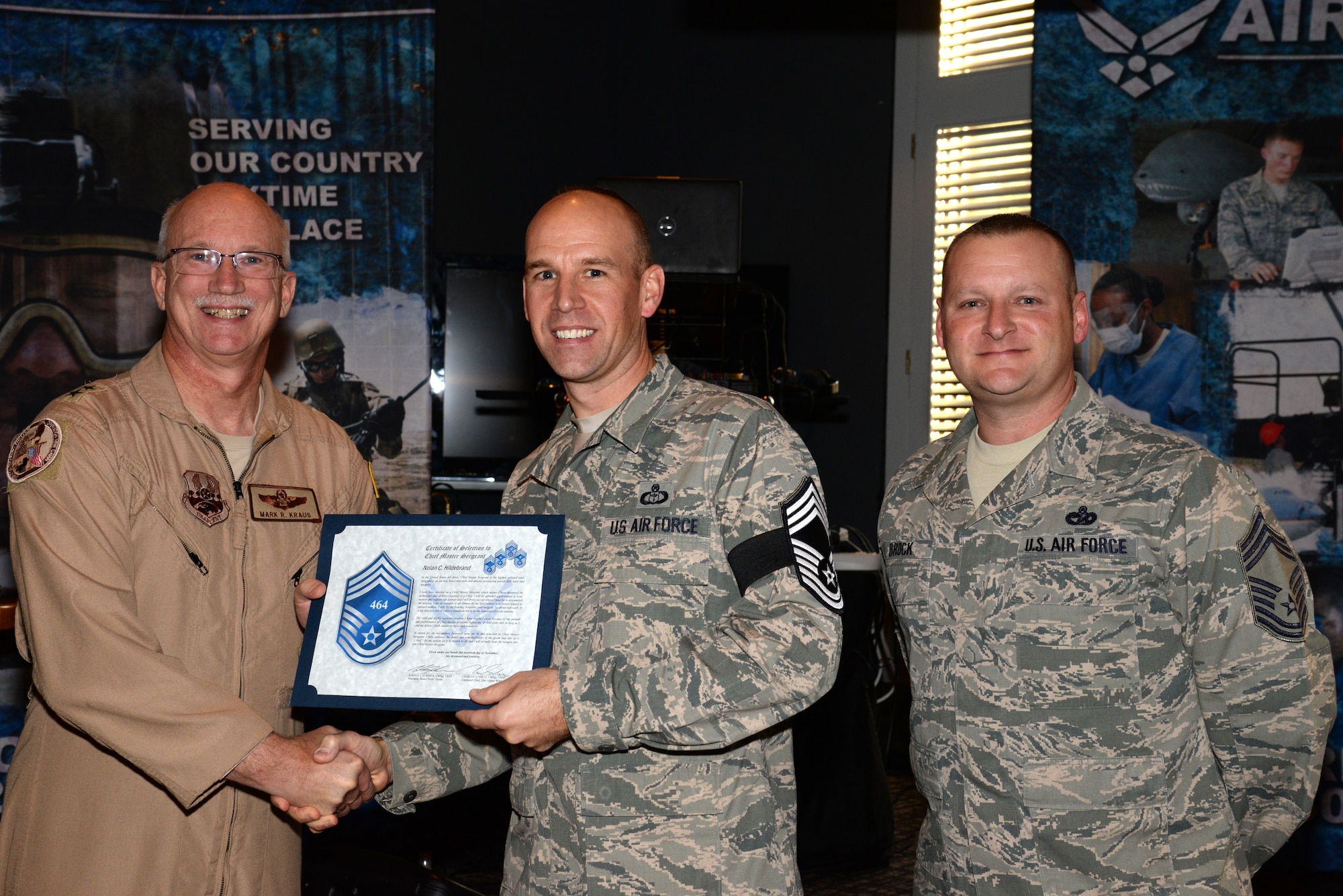 U.S. Air Force Senior Master Sgt. Nolan Hildebrand, 28th Operational Weather Squadron operations superintendent, receives his chief master sergeant select promotion certificate from Maj. Gen. Mark Kraus, Air National Guard assistant to the Combined Forces Air Component Commander at Shaw Air Force Base, S.C., Nov. 20, 2014. Members of the Team Shaw Chief’s Group visited each of the chief selects unit’s to congratulate them on their promotion. (U.S. Air Force photo by Airman 1st Class Jonathan Bass/Released)