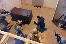 341st Security Forces Group Tactical Response Force Flight 911 team members challenge a suspect during an active shooter training exercise at Malmstrom Air Force Base, Mont., Nov. 18. During the training exercise, members practiced breaching and assaulting. (U.S. Air Force photo/Airman 1st Class Joshua Smoot)