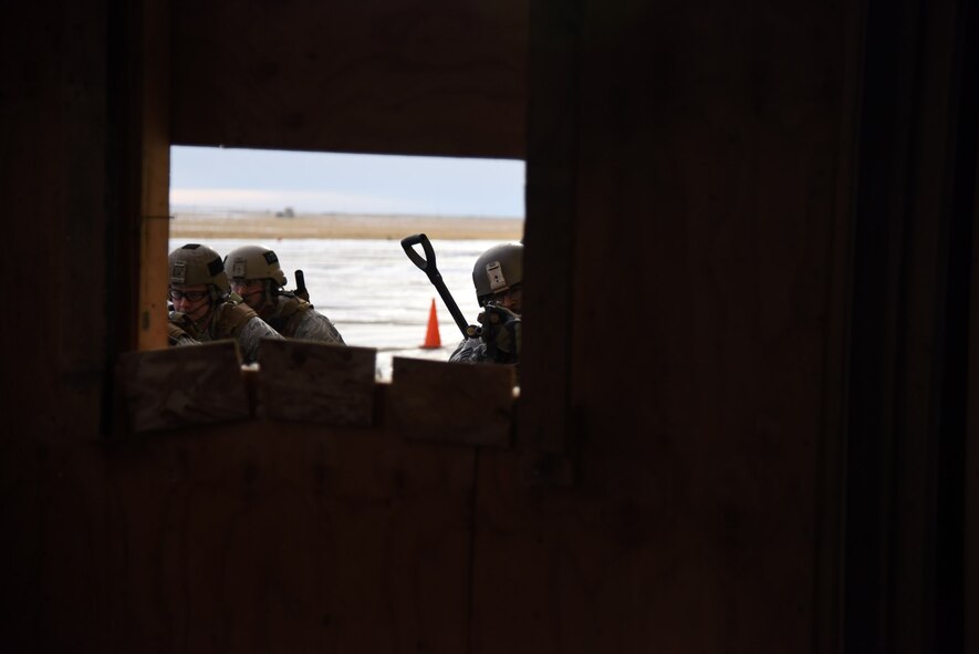 341st Security Forces Group Tactical Response Force Flight 911 team members move to their designated breach point during a training exercise at Malmstrom Air Force Base, Mont. Nov. 18. During the training exercise, members practiced breaching and assaulting. (U.S. Air Force photo/Airman 1st Class Joshua Smoot)