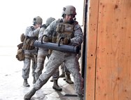 Staff Sgt. Jarrid Wrege, 341st Security Forces Group Tactical Response Force member, uses a ram to breach into a room during a training exercise at Malmstrom Air Force Base, Mont., Nov. 18. To begin training as a breacher, students attend a two-week long course which teaches them how to properly utilize tools and courses which demonstrate how to safely build and detonate explosives used for facility entry. (U.S. Air Force photo/Airman 1st Class Joshua Smoot)